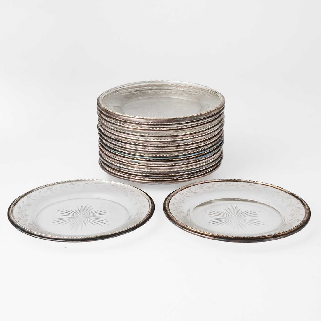 Set of Sixteen Continental Wheel-Engraved Silver Rimmed Small Plates: Diameter 6 1/4 inches. (16)