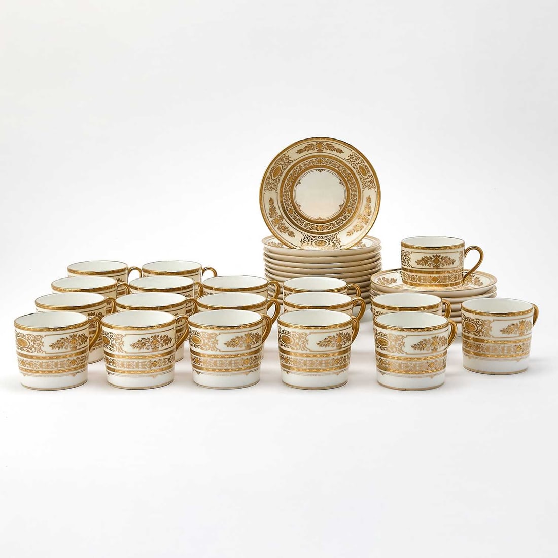 Set of Eighteen Minton Gilt-Decorated Porcelain Demitasse Cups and Saucers: Retailed by T. Goode & Co., Ltd., in the Argyle pattern, pattern no. H.4965, 20th century He