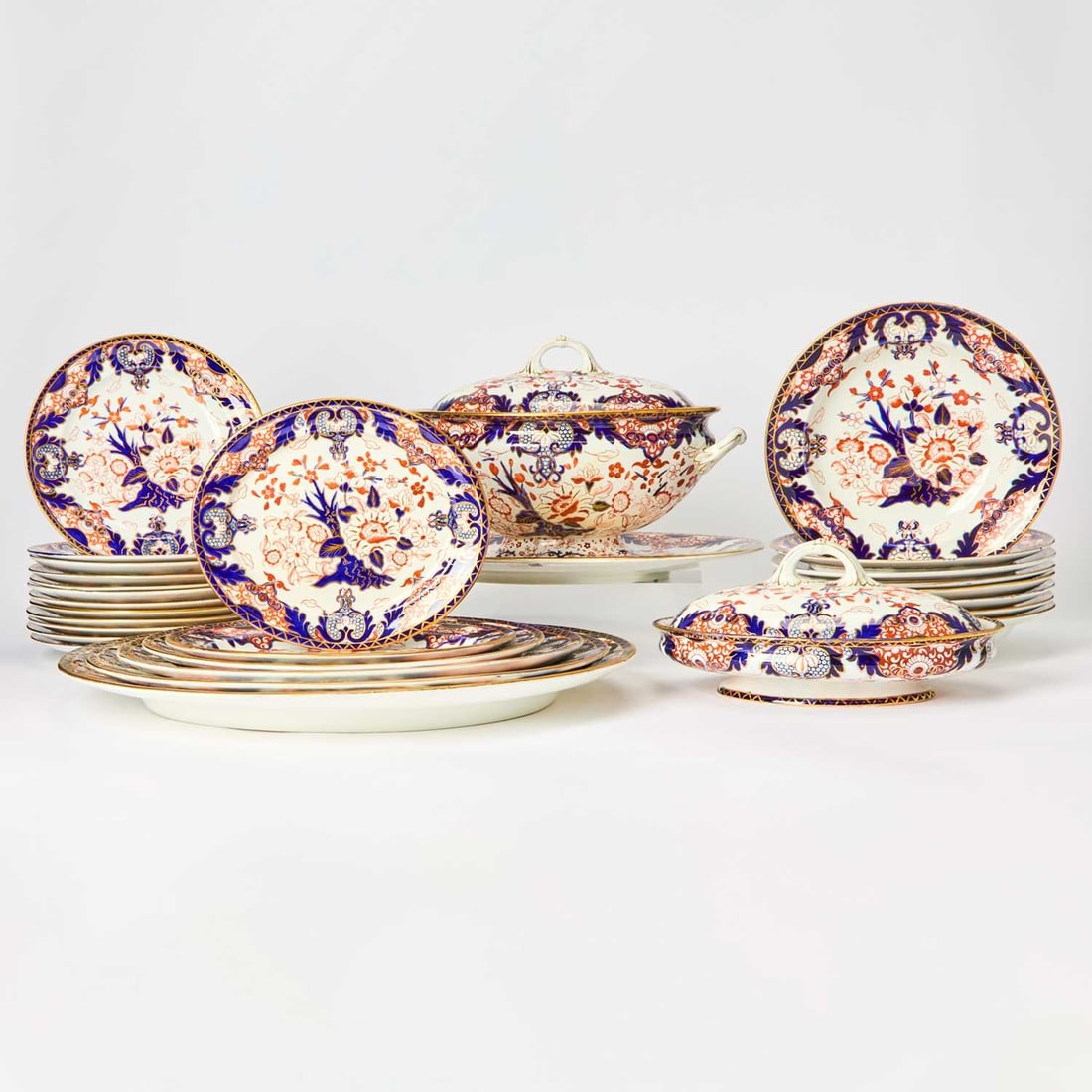 Royal Crown Derby Porcelain "Kings" Pattern Partial Dinner Service: 1878-1914 Each with stylized blossoms in cobalt blue and iron-red, within a C-scroll and foliate border, each with impressed crown and Derby and red maker's marks, comprising: Twenty lunch plates, dia