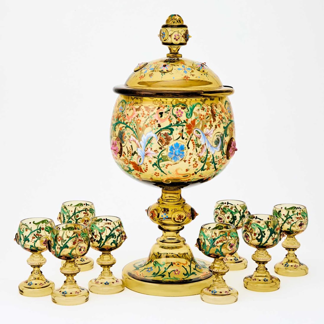 Continental Blown and Enameled Decorated Punch Set: Attributed to Moser In transparent amber colored glass, comprising a punch bowl and cover and eight punch cups. Height of punch bowl 17 1/2 inches. (9)
