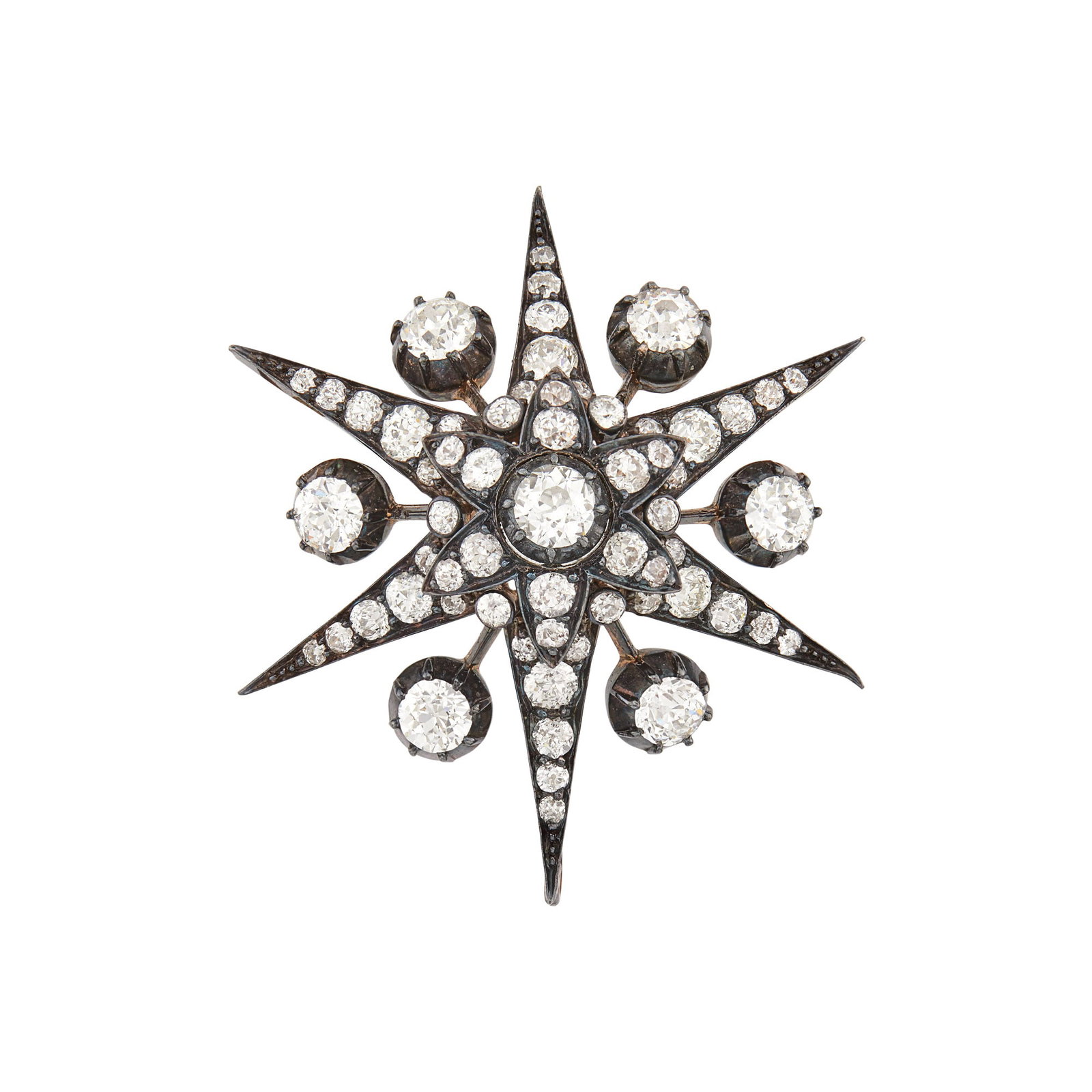 Blackened Silver, Gold and Diamond Star Pendant-Brooch: 7 old-mine cut diamonds ap. 3.50 cts., 54 old-mine cut diamonds ap. 285 cts., brooch fitting detachable, hinged pendant loop missing, ap. 11.2 dwts. Tests as 14 kt. Diamonds: H-I-J-VS, several SI. 1 3