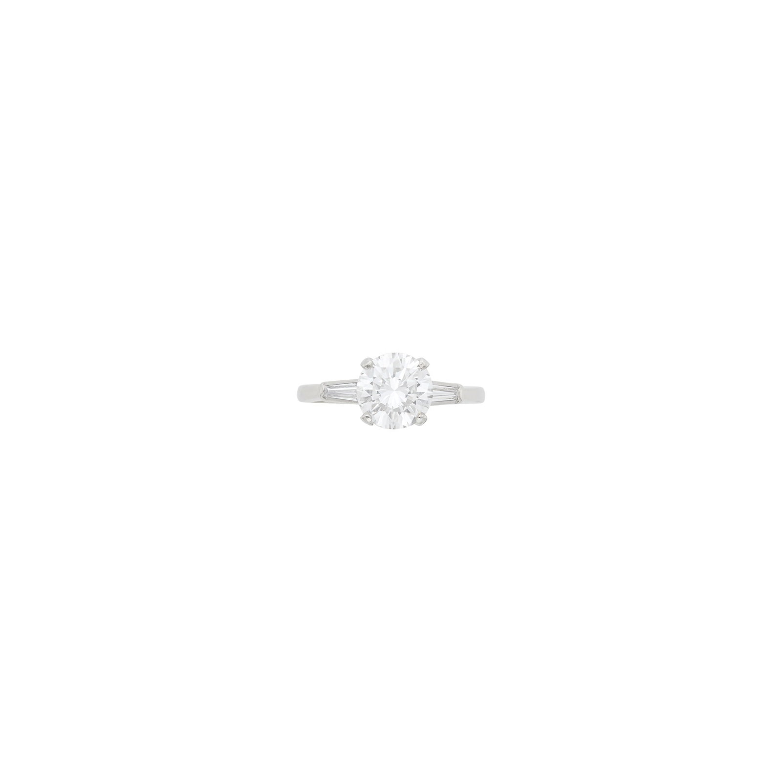 Platinum and Diamond Ring: One round diamond weighing 1.70 cts., 2 tapered baguette diamonds. Size 5 3/4. With GIA report no. 6237923437 stating E color, VS1 clarity. Diamond: E-VS1, no f