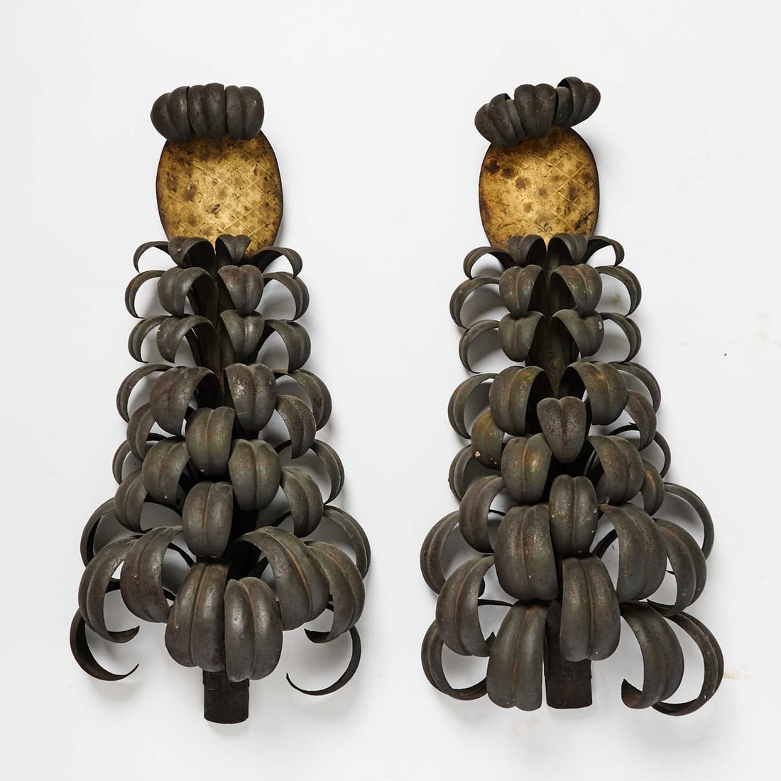 Pair of Tôle Pineapple Wall Ornaments: In the manner of Maison Jansen, mid 20th century Height 30 1/2 inches, width 12 1/2 inches, depth 6 inches Some dings and dents, rubbing to decoration.