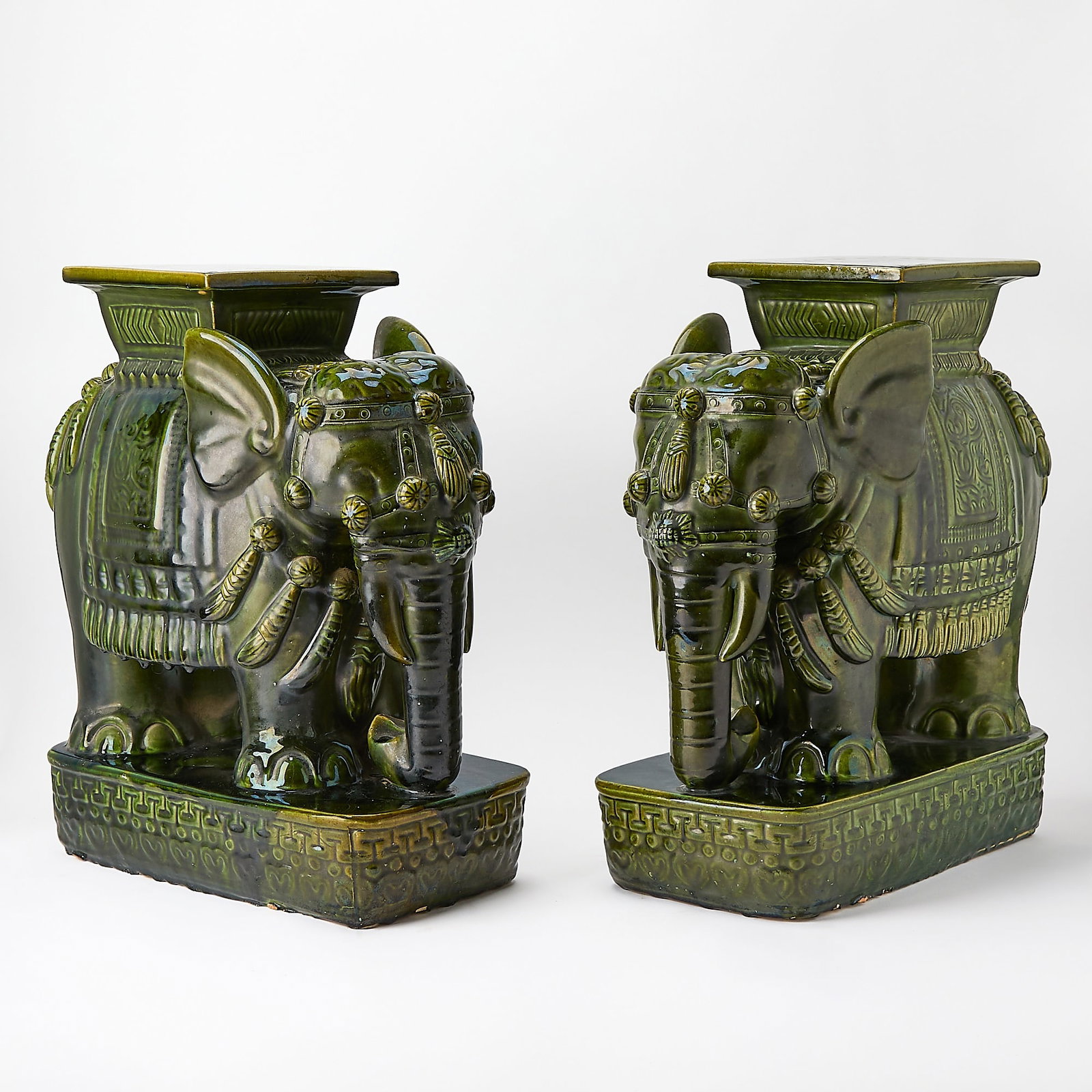 Pair of Southeast Asian Style Green Glazed Elephant-Form Garden Seats: Height 22 3/4 inches, width 9 1/2 inches, depth 19 1/4 inches One with restoration to corner.