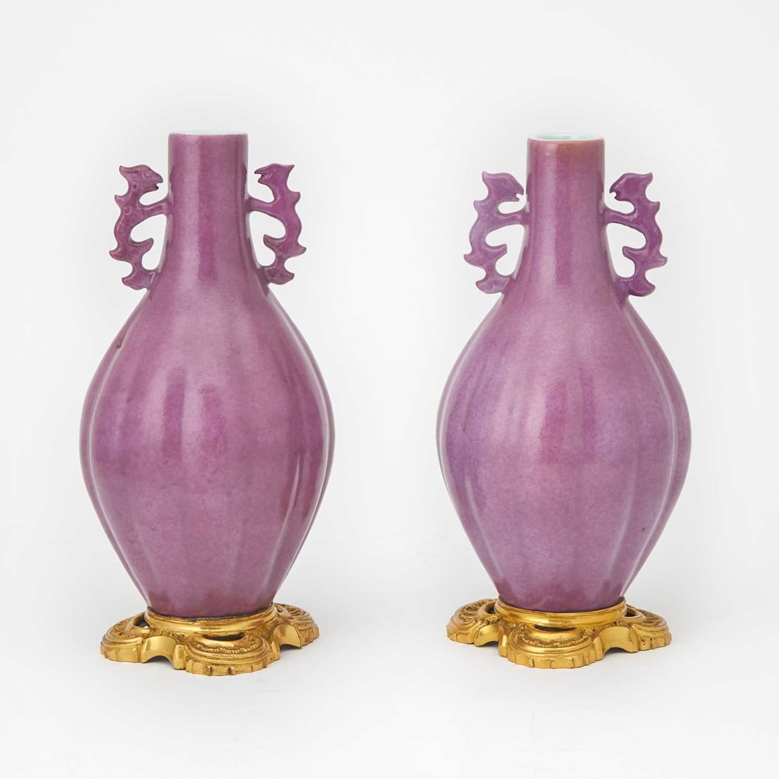 Pair of Chinese Porcelain Vases with Gilt Metal Mounts: 20th century Height 11 inches One of the handles of slightly different construction and color tone; does not fluoresce under UV light.