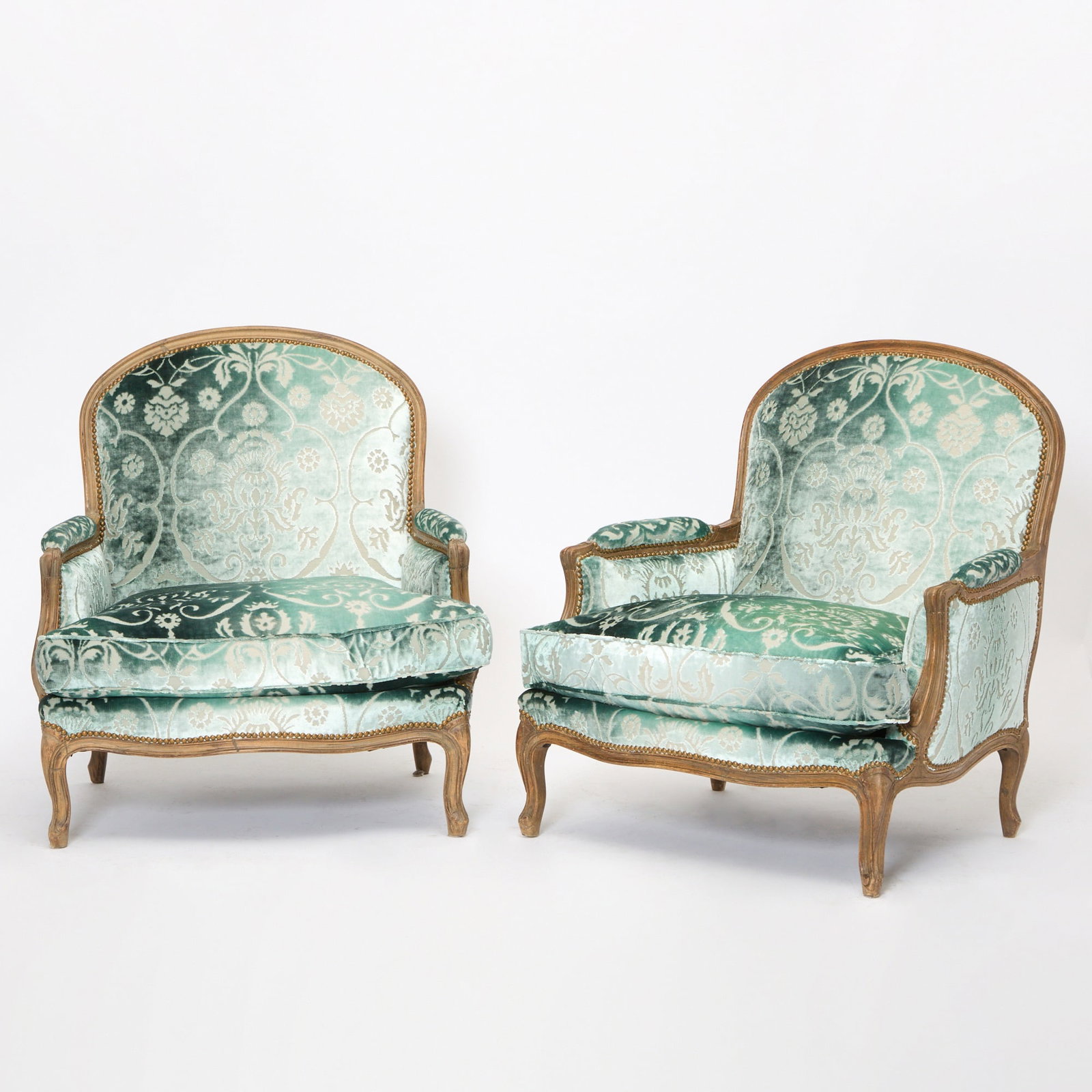 Pair of Louis XV Style Walnut Bergères: In teal embossed silk damask upholstery. Height 36 1/2 inches, width 32 1/2 inches, depth 23 1/2 inches