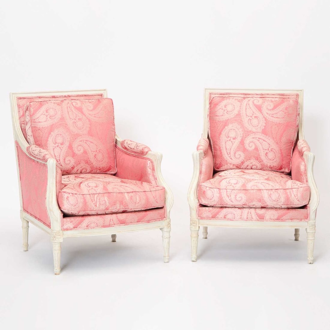 Pair of Louis XVI Style Painted Bergères: In pink paisley upholstery. Height 34 inches, width 27 inches, depth 19 inches
