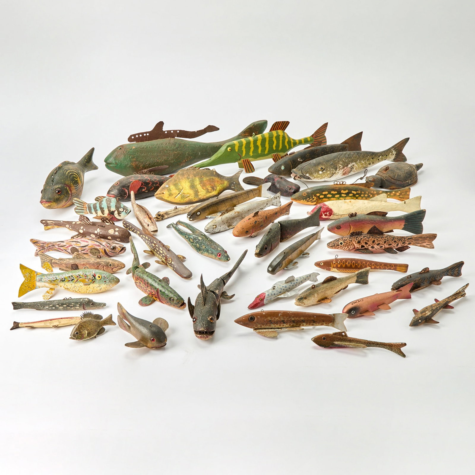 Group of Folk Art Metal-Mounted Painted Wood Fish: 20th century Length of largest 17 1/2 inches Chips and losses to painted elements, evidence of rust to metal parts.