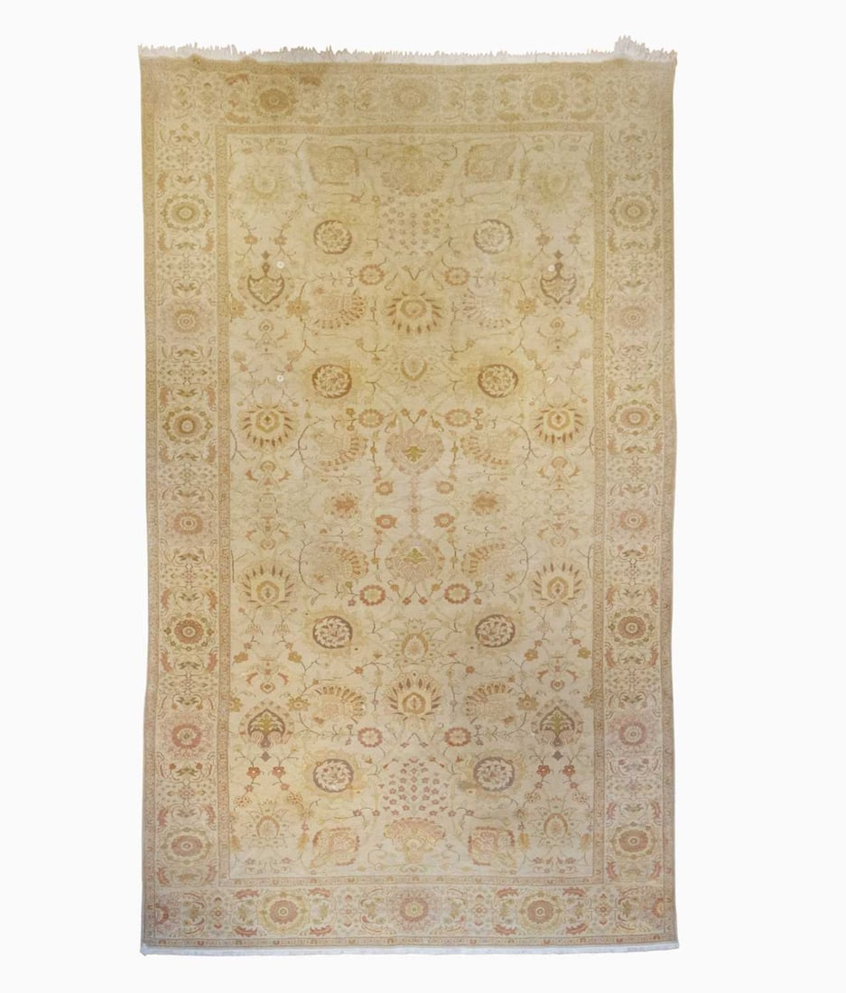 Sultanabad-Style Carpet: Egypt, contemporary The ivory field with large-scale floral vinery overall is within a rosette and leaf border. (20' 2" x 10' 11") 2 small holes, dog-eared corner, soiled/stained areas