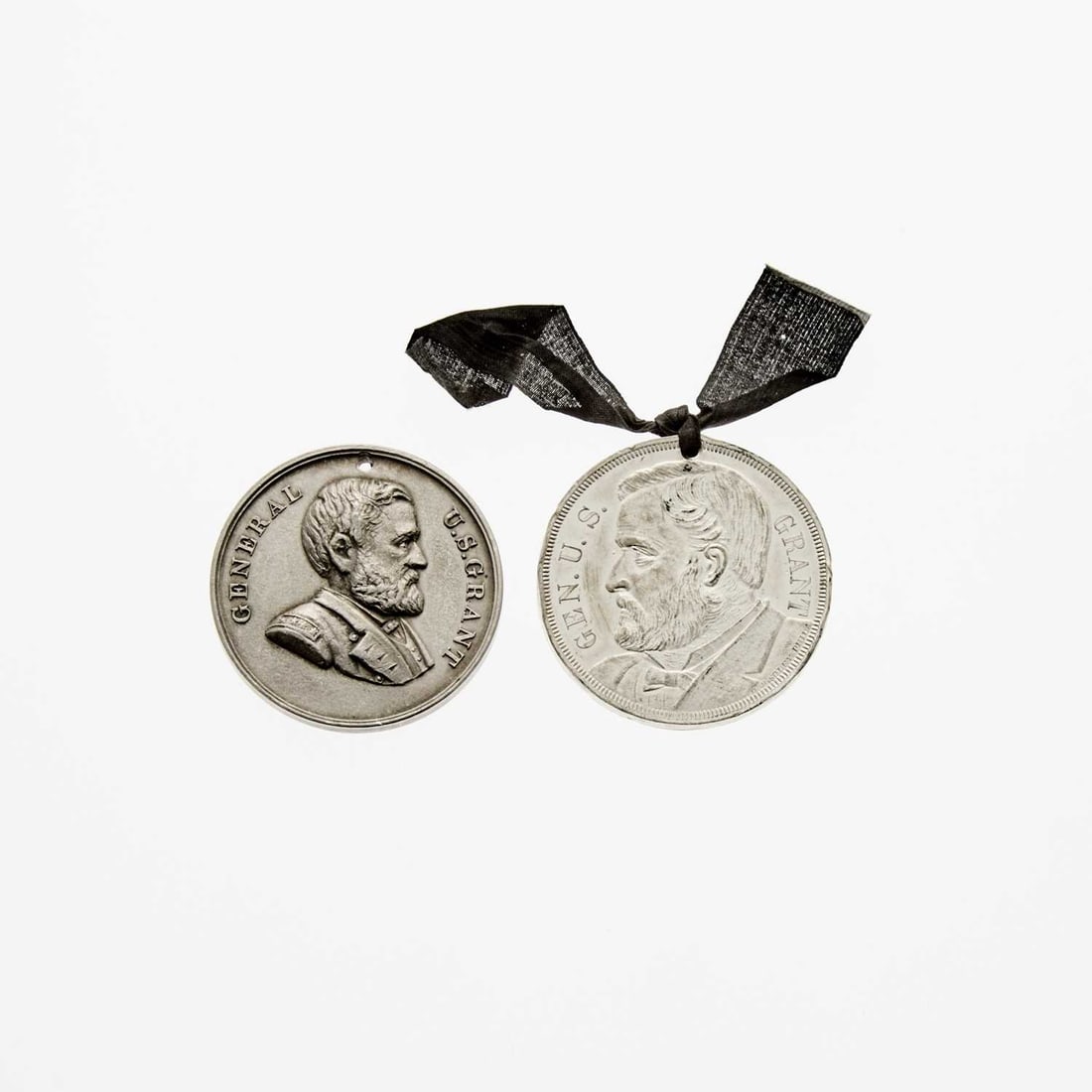 United States. Pair of 19th Century Ulysses S. Grant Memorial Medals. White Metal.: Two items: "Saviour of Our Stars and Stripes" Medal. Prooflike. White Metal. 38mm. OBV: Grant in profile, facing right. REV: Lines of text outlining year-dates of Grant's major achievements. Holed for