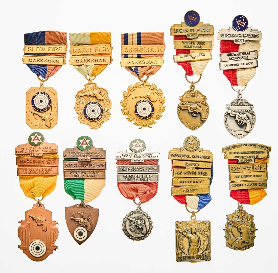 United States. Group of 1950s Pistol Marksmanship Medals and Awards. Conditions Vary.: Approximately 57 pieces. Honors marksmanship in a variety of calibers, ranging from .22 to .45. Many feature detailed representations revolvers and semiautomatic handguns. Vast majority date to the la