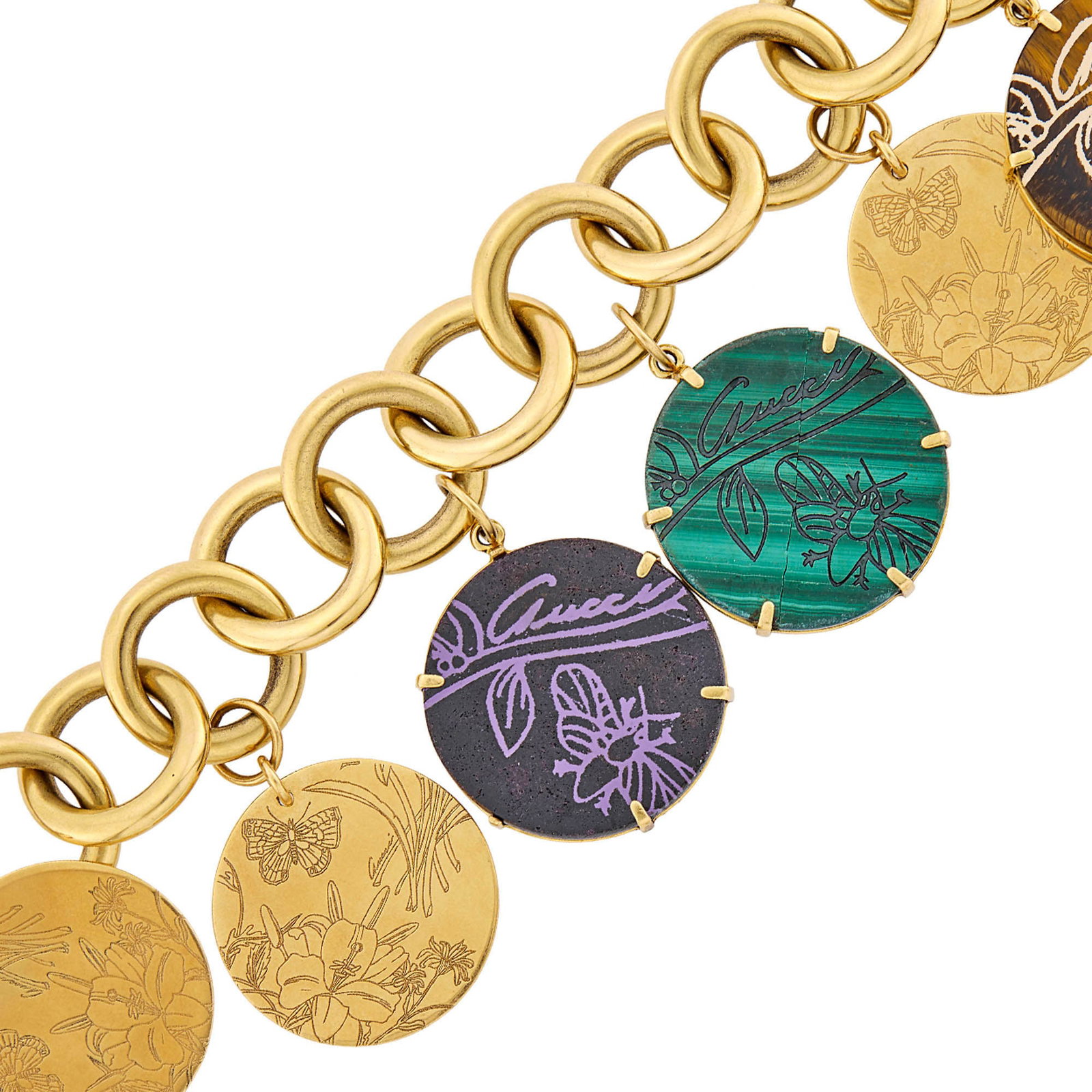 Gucci Gold and Hardstone Charm Bracelet: 18 kt., 3 engraved circlular malachite, sugilite and tiger's eye slices, purple and white lacquer, signed Gucci, Made in Italy, with Italian mark, ap. 55.6 dwts. gross. Inner cir. 6 3/4 inches.
