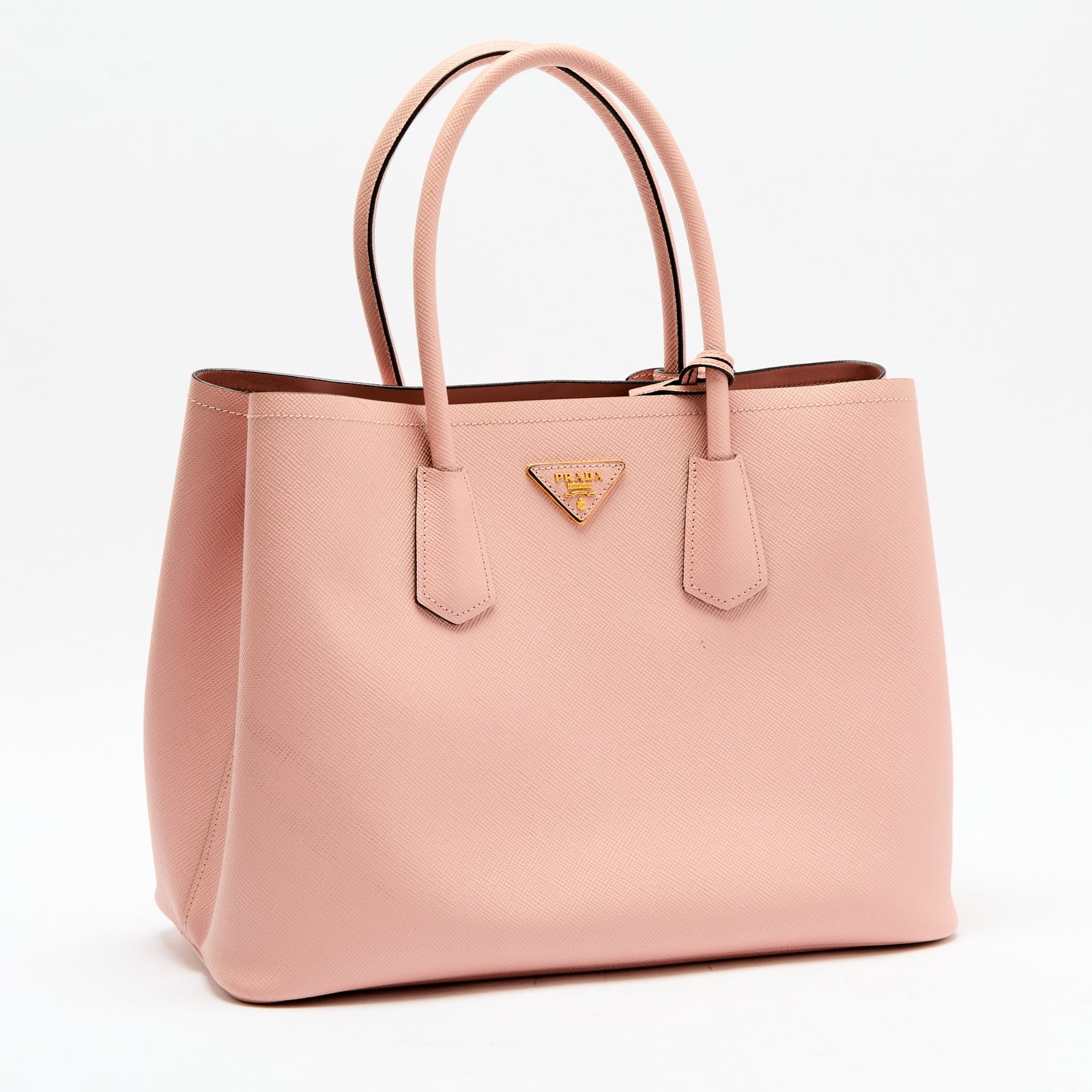 Prada Double Saffiano Pink Leather Bag: Dual top handles, gold-tone hardware, two large interior compartments, one small center compartment with magentic flap closure, with detachable shoulder strap, signed Prada. 14 x 10 1/4 x 6 3/4 inches