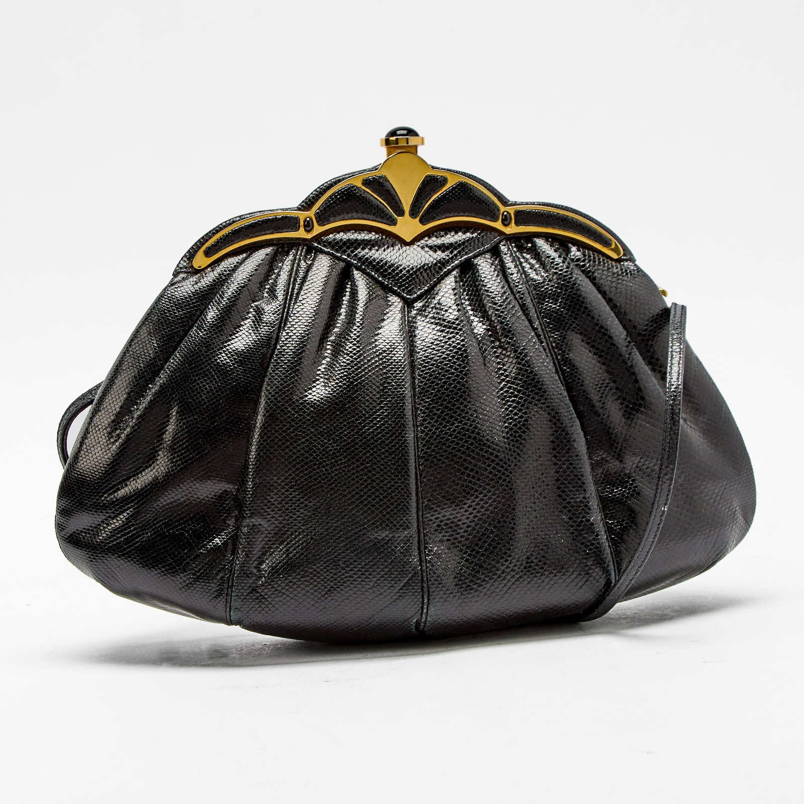 Judith Leiber Black Lizard Skin Clutch: Black lizard skin with gold-tone hardware and round cabochon black stone thumbpiece, black fabric interior with side zippered pocket, signed Judith Leiber, 1986. 11 x 7 x 3 inches.