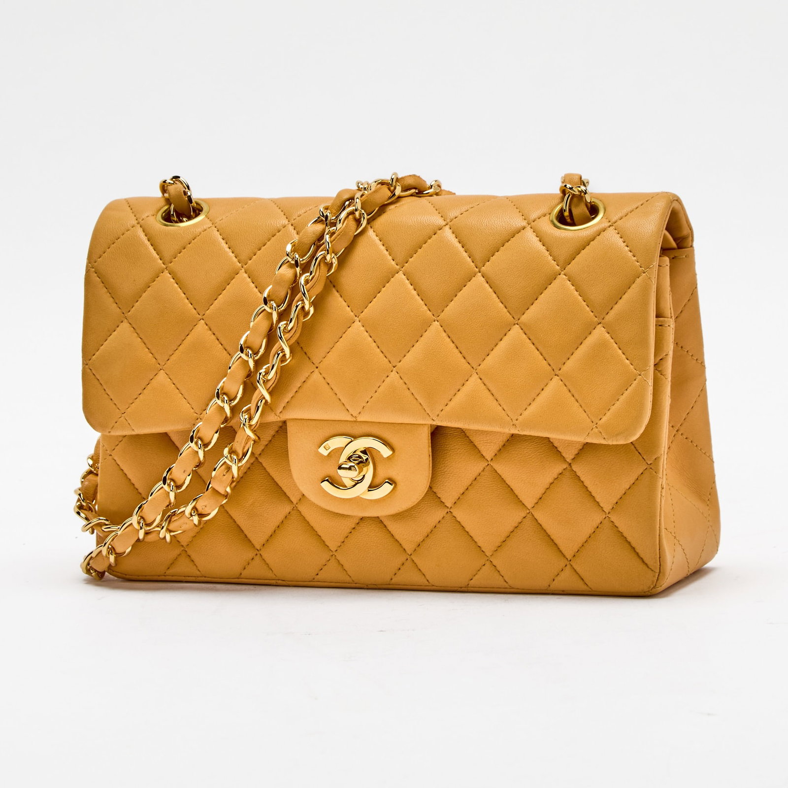 Chanel Tan Lambskin Leather Double Flap Bag: Double flap bag with gold-tone hardware, double 'CC' turn lock closure and woven-in leather chain strap, matching leather interior with two compartments, main compartment with two slip pockets, zipper