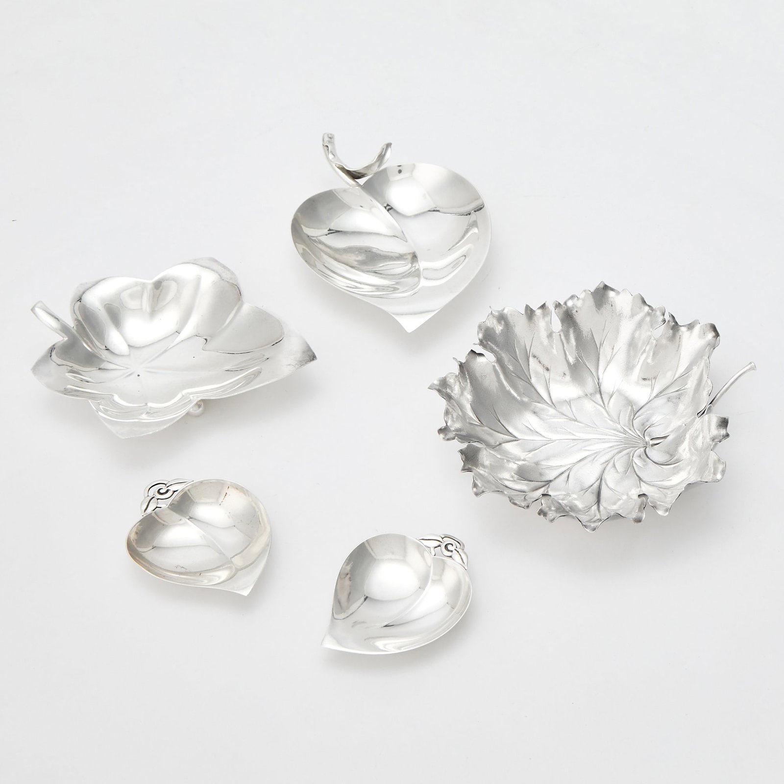 Group of Five Tiffany & Co. and Buccellati Sterling Silver Leaf Form Dishes: Second half 20th century Comprising four Tiffany & Co. examples, length of largest 6 1/8 inches, length of middle 5 3/4 inches, and length of smaller pair 3 1/4 inches; and a Buccellati example, l