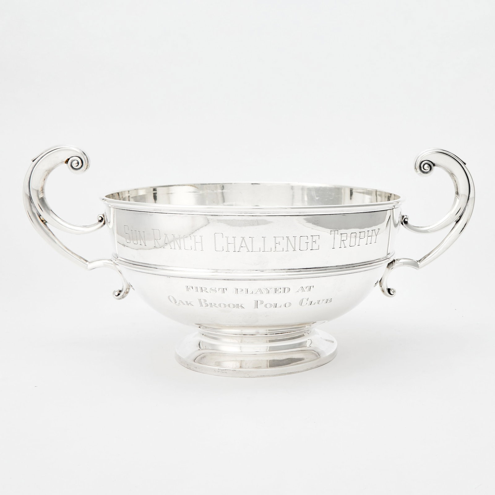 George V Sterling Silver Two-Handled Footed Trophy Bowl: D. & J. Wellby Ltd., London, 1922 Engraved SUN RANCH CHALLENGE TROPHY / FIRST PLAYED AT OAK BROOK POLO CLUB and 1972 RED DOORS FARM. Height of body 7 inches, length over handles 18 3/4 inches. App