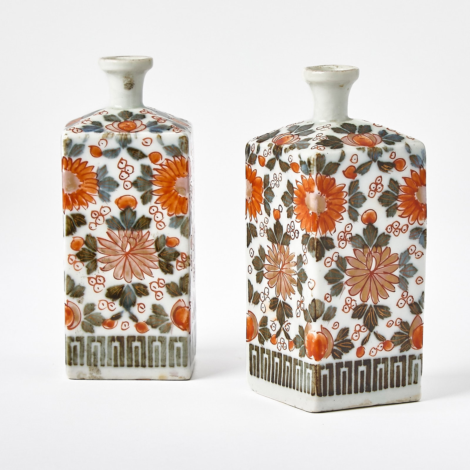 Pair of Samson Japanese Style Imari Porcelain Bottles: Mid-19th century Of slightly tapering square form, overall painted with blossoming chrysanthemums in rich red and gilt above a geometric border. Height 4 3/4 inches (12.2 cm). Provenance: Mark & M
