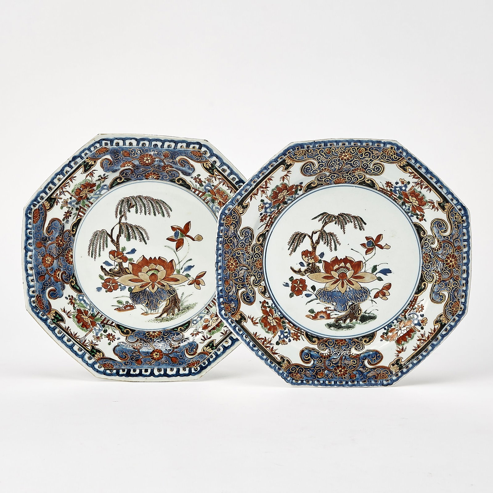 Pair of Chinese Export Porcelain Imari Plates: First half 18th century Each octagonal, painted with a willow near a lotus pond within a floral and lappet and cell border. Width 8 3/4 inches (22.2 cm) Provenance: Mark & Marjorie Allen Antiques.