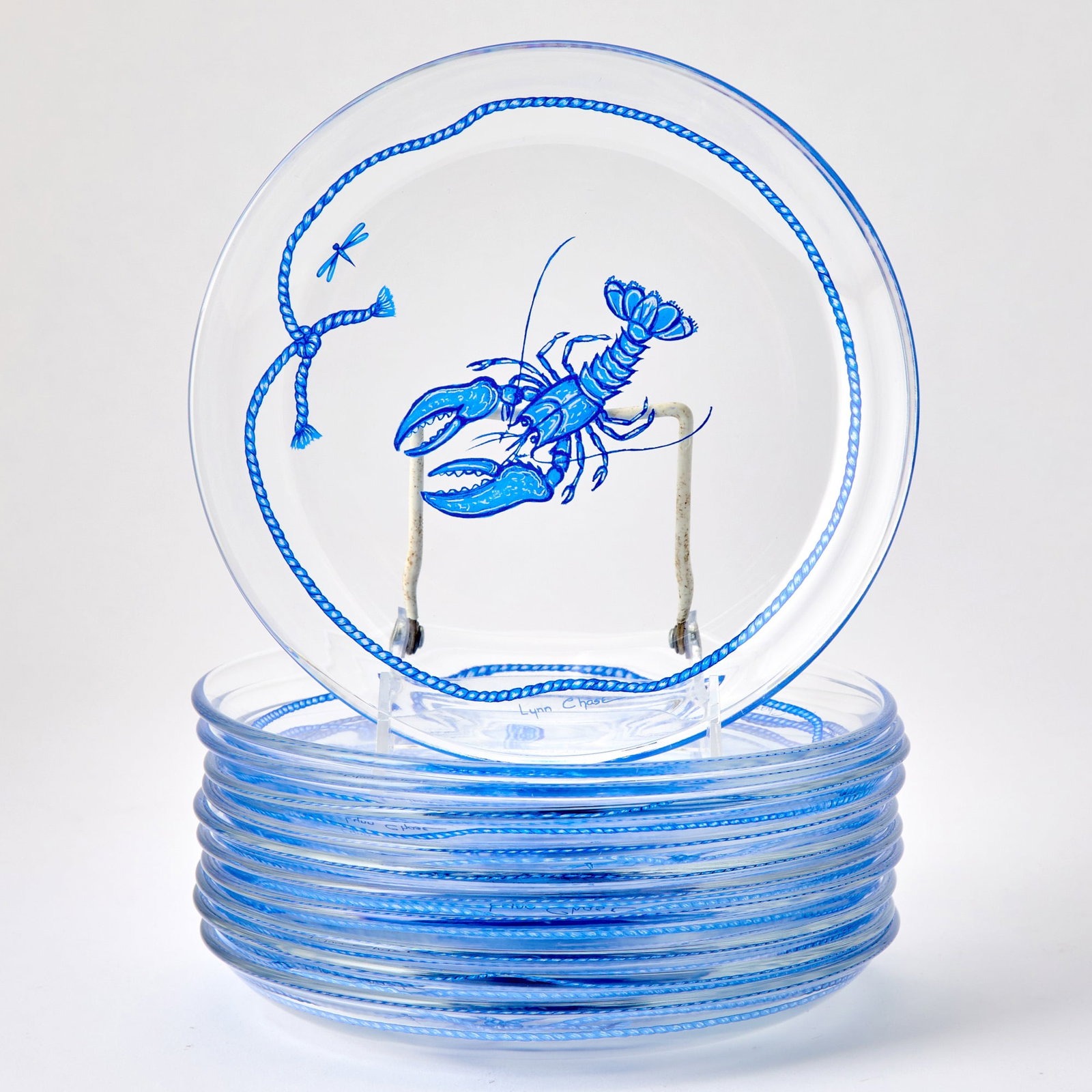Set of Eleven Lynn Chase Glass "Costa Azzurra" Pattern Dessert Plates: Each in colorless glass, enameled in blue and white with marine animals and shells within a tied rope border. Diameter 8 1/4 inches.