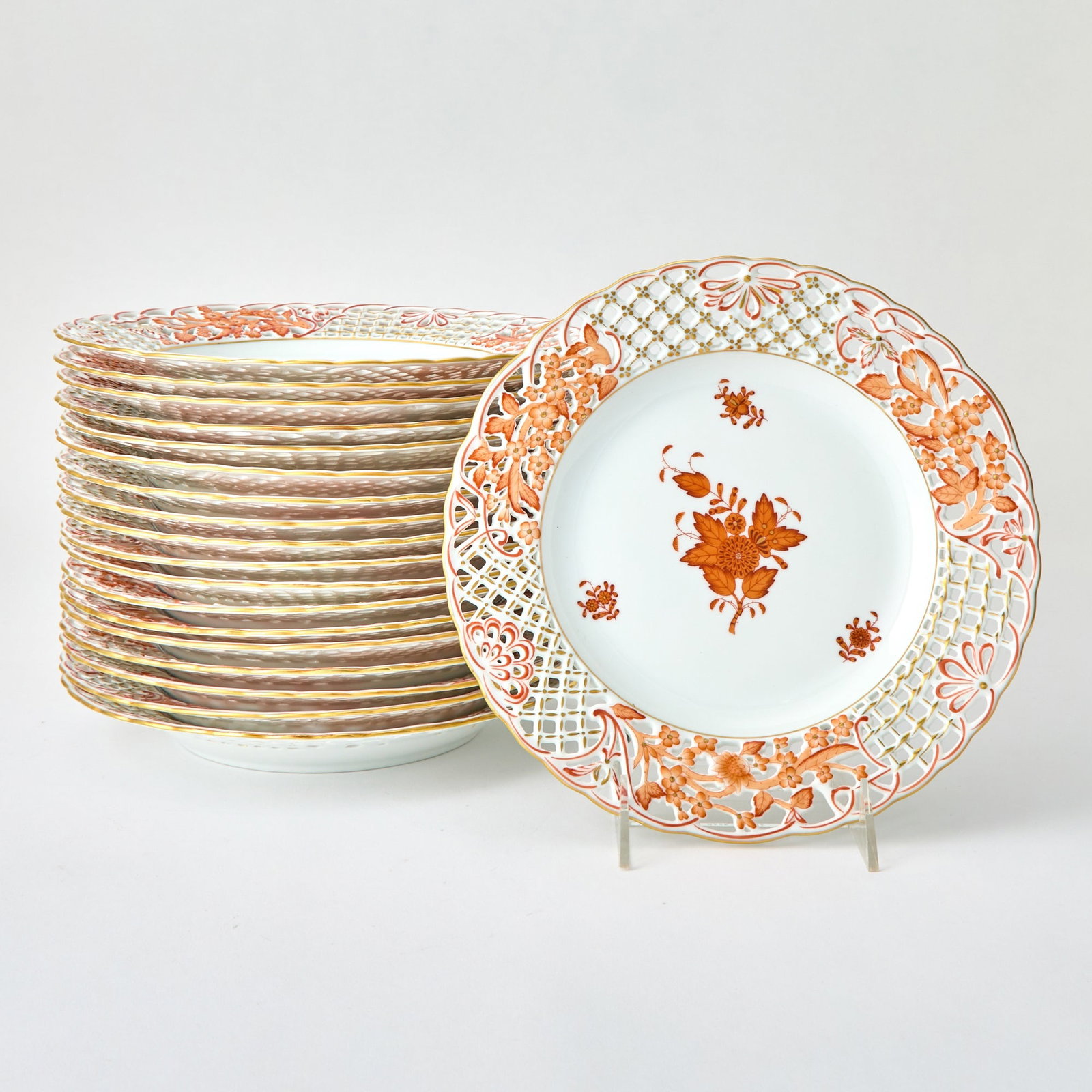 Set of Nineteen Herend Pierced Porcelain "Chinese Bouquet Rust" Pattern Plates: Diameter 9 5/8 inches.