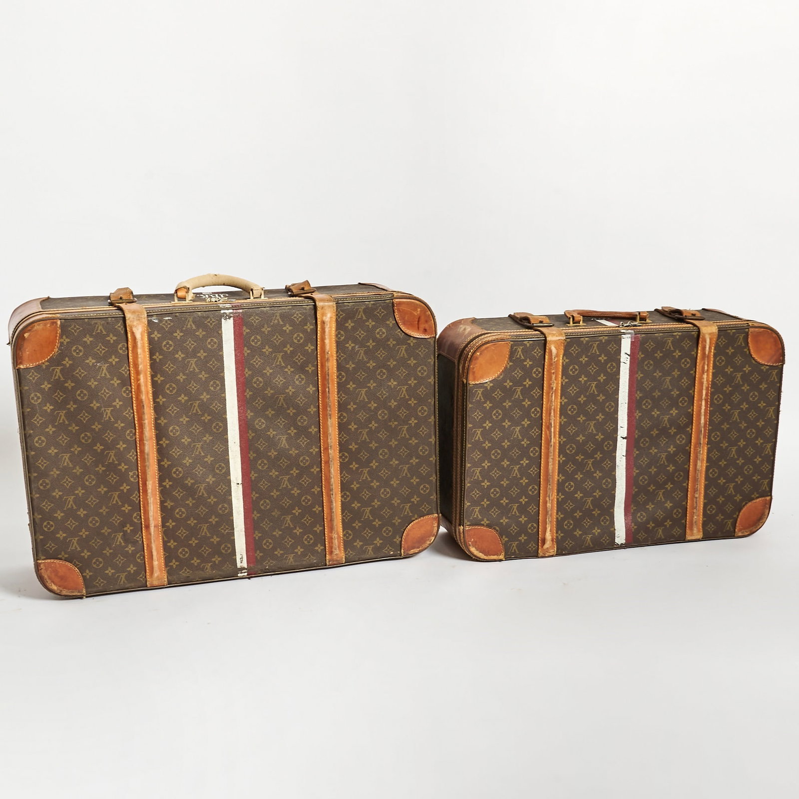 Two Louis Vuitton Suitcases: Each with painted monogram JBK and stripe. Larger 31 inches x 21 inches, smaller 27 inches x 17 1/2 inches.