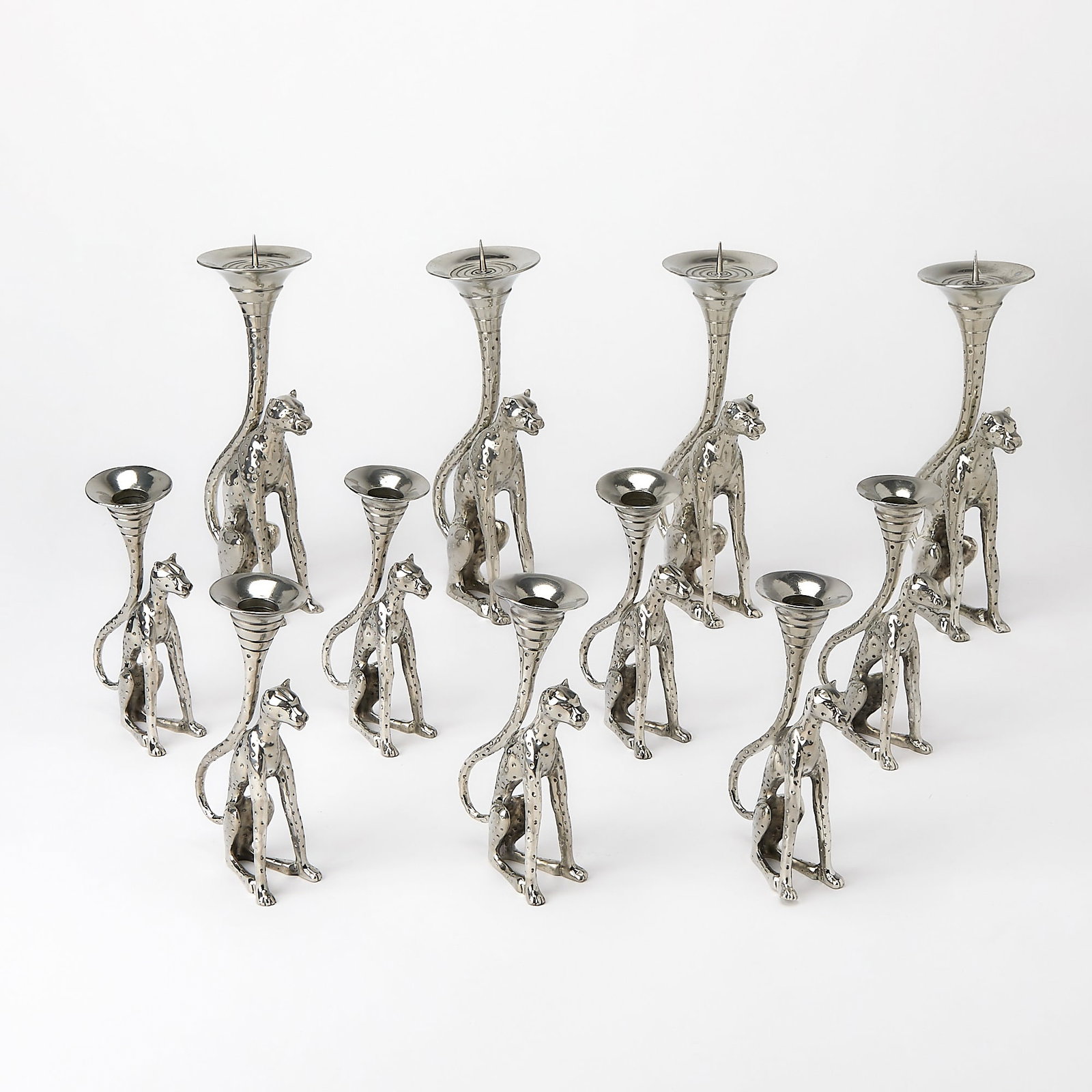 Eleven Diana Carmichael Pewter Cheetah-Form Candlesticks: Modern In two sizes. Height of taller size 10 inches; height of smaller size 7 inches.