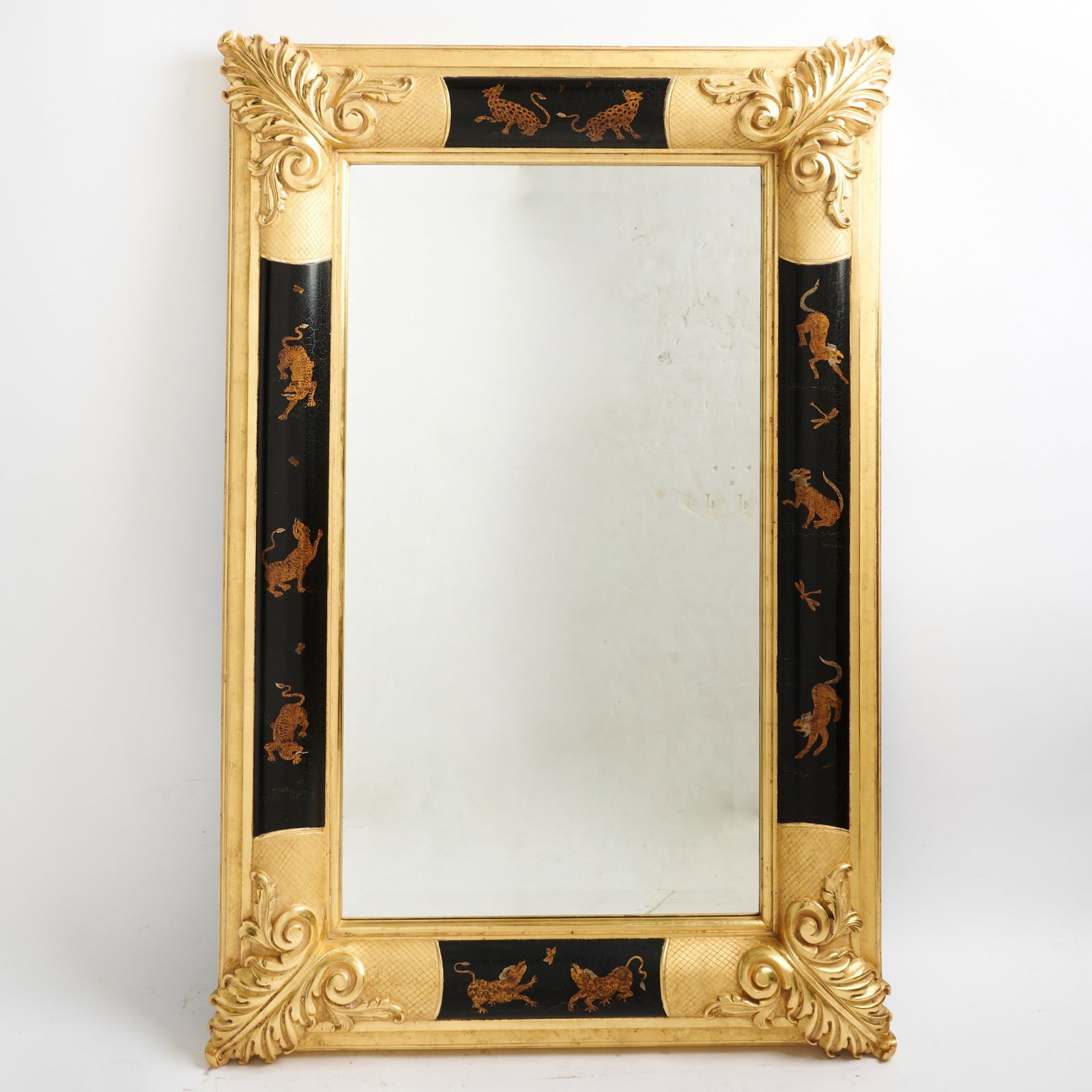 Regency Style Parcel-Gilt and Japanned Mirror: 20th Century The rectangular frame with gilt acanthus at the corners, decorated with panthers on a black ground. Height 5 feet, width 40 inches.