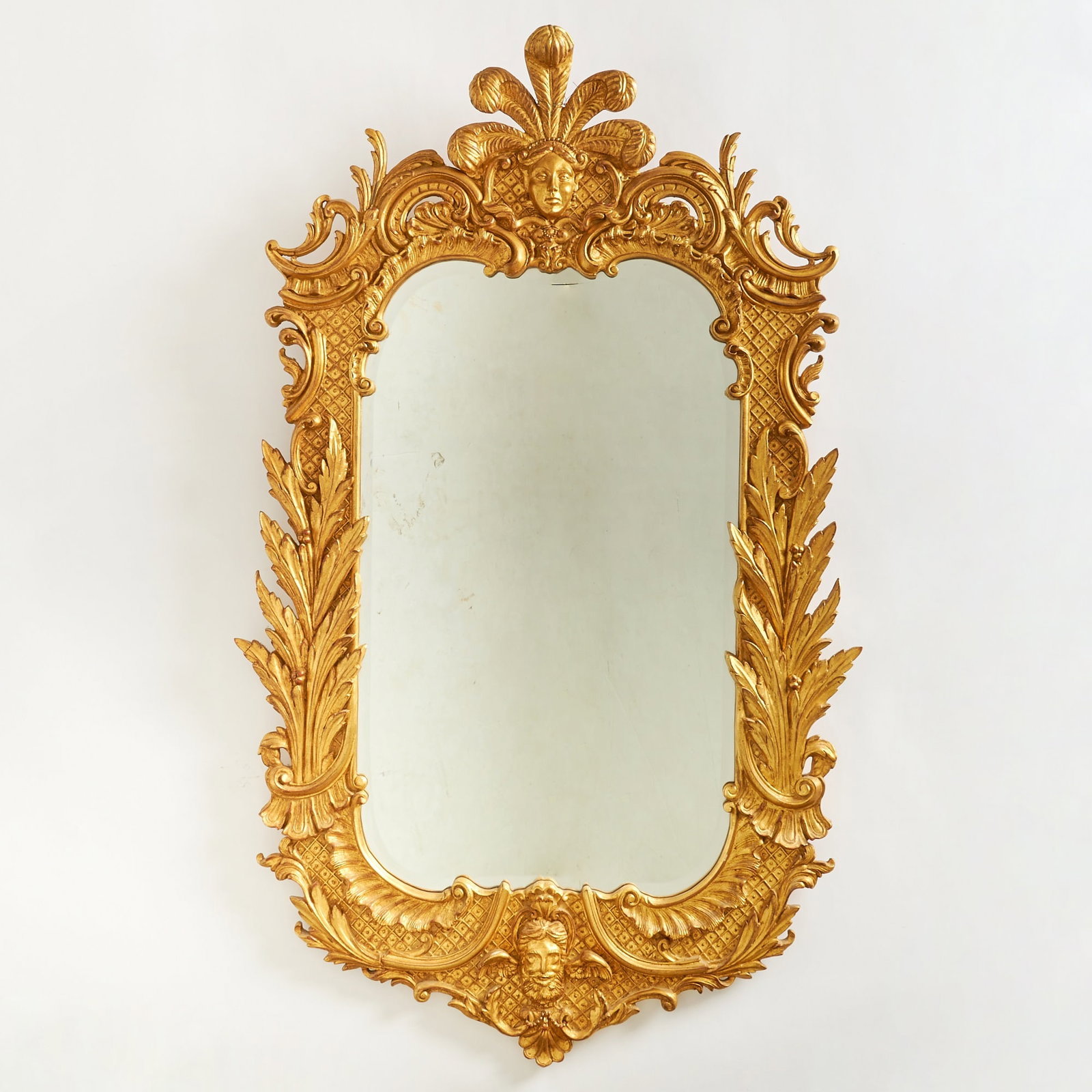 Rococo Style Carved Giltwood Mirror: 20th century Height 58 inches, width 34 inches Provenance: Plaza Hotel, New York