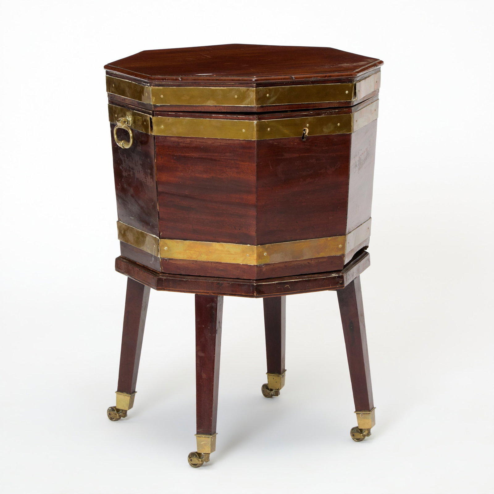 George III Mahogany and Brass Bound Hexagonal Cellarette: Circa 1790 Height 26 1/2 inches, width 18 inches, depth 18 inches. damaged with small pieces of missing mahogany, lifting brass