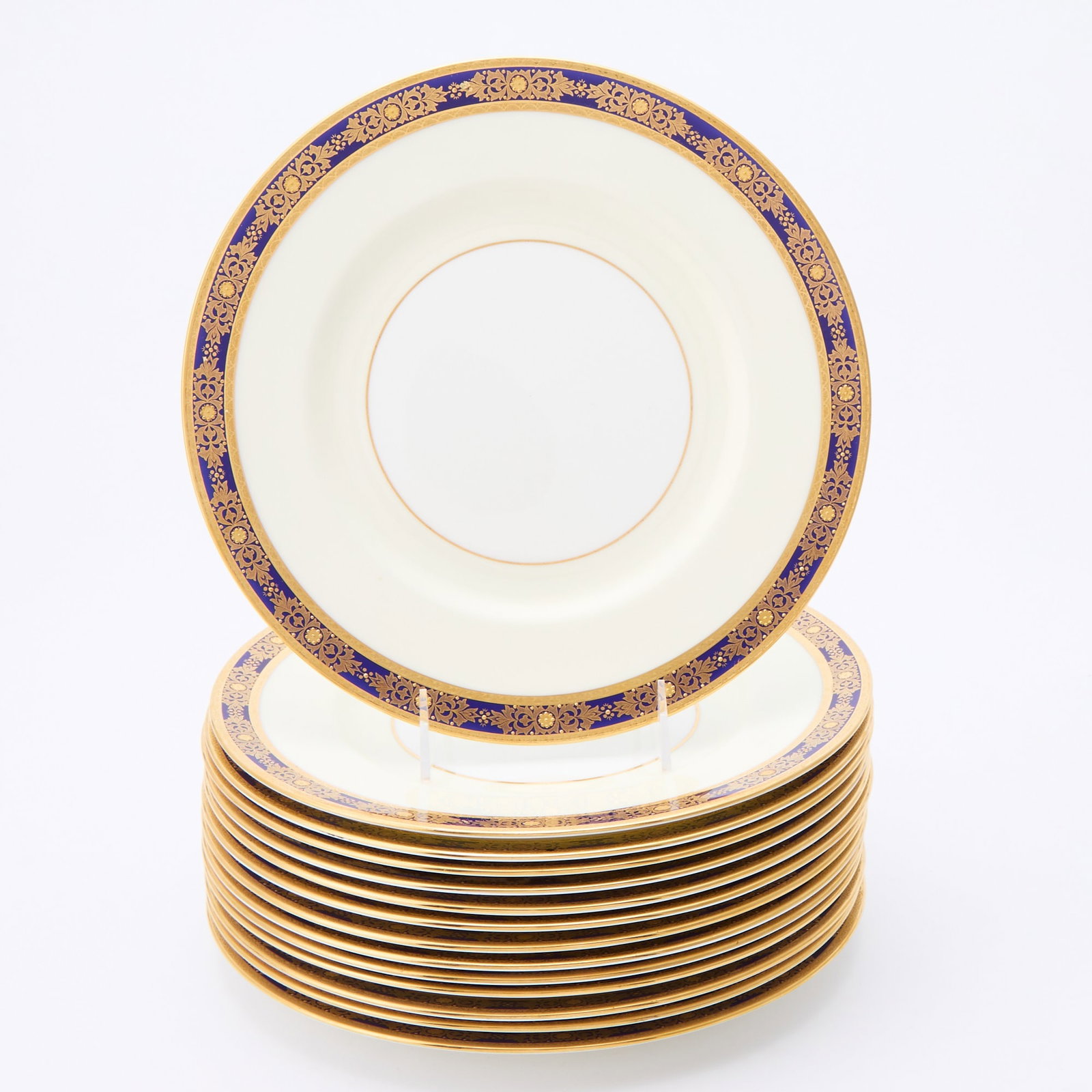 Set of Fourteen Minton for Tiffany & Co. Porcelain Dinner Plates: Cobalt blue and raised gilt decoration on a white and cream ground. Diameter 10 3/4 inches.