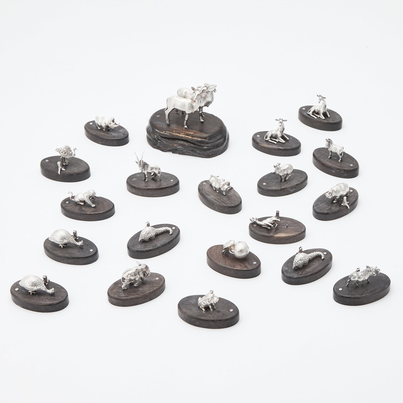 Group of Patrick Mavros Sterling Silver and Dark Stained Wood Table Ornaments: Late 20th/early 21st century Comprising a centerpiece and eighteen placecard holders. Length of centerpiece 4 inches, length of placecard holders 2 1/4 inches, weighted.