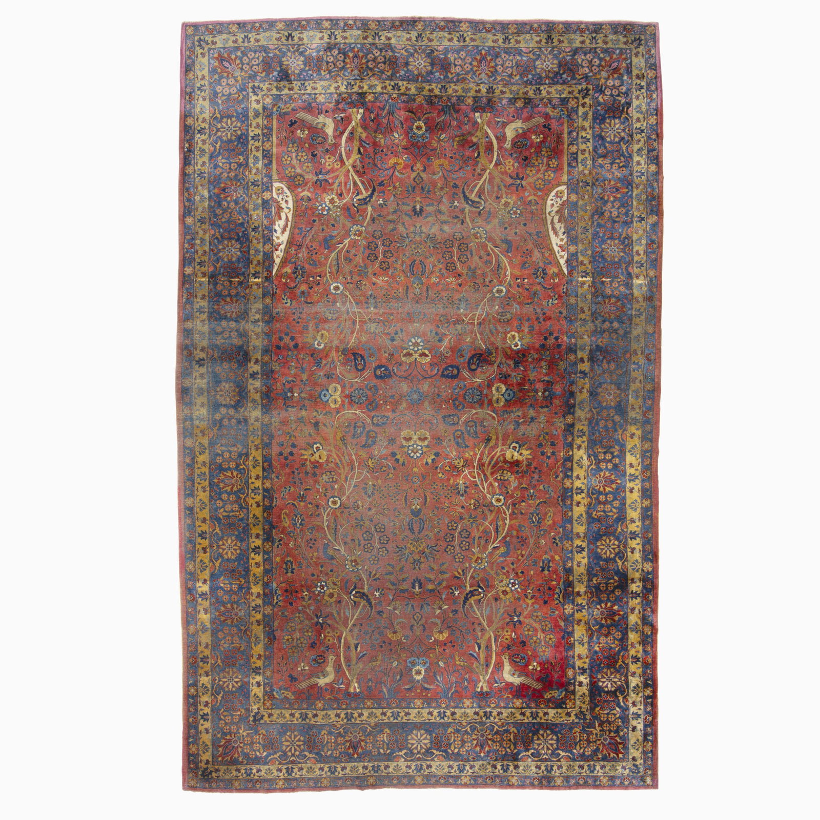 Kashan Carpet: Central Persia, circa 1925 With an overall pattern of birds amongst trees on a madder field, within an indigo floral vinery border. (12' 4" x 7' 10") Areas of wear, slightly dry foundation