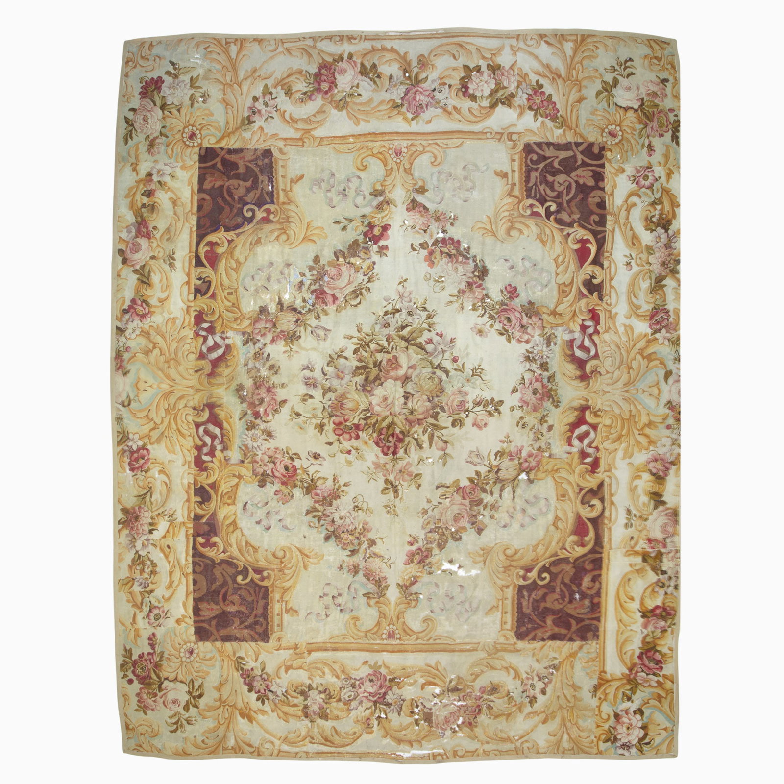 Louis Philippe Aubusson Fragmentary Carpet: France, Mid-19th Century The central spray flanked by garlands on the ivory field is within a border filled with scrolling acanthus leaves. (16' 7" x 13' 2") Cut and pieced together, holes, patches,
