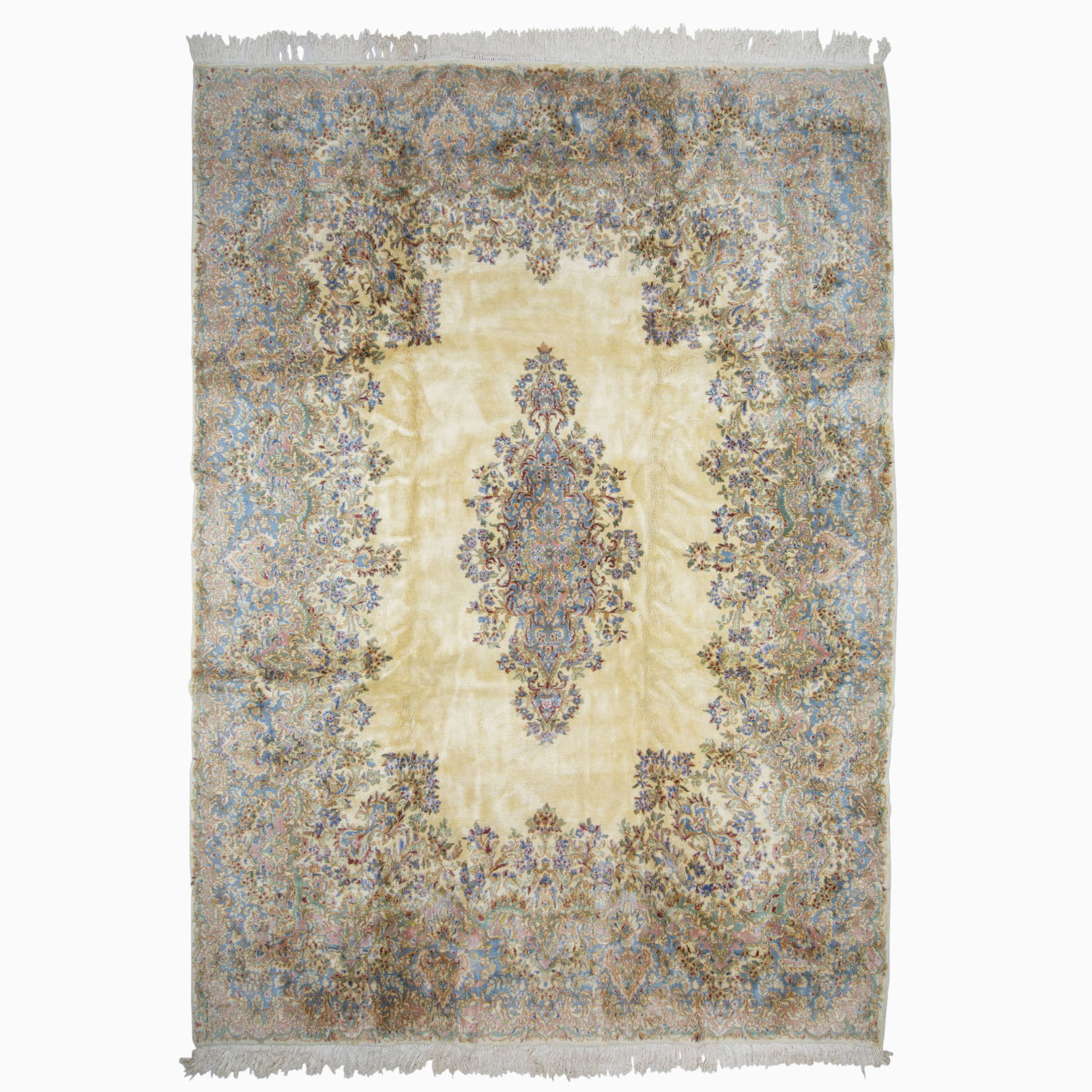 Kerman Carpet: Southeast Iran, circa 1975 The open ivory field with a central floral pendant medallion is within a sky-blue palmette border. (13' 1" x 9' 5")
