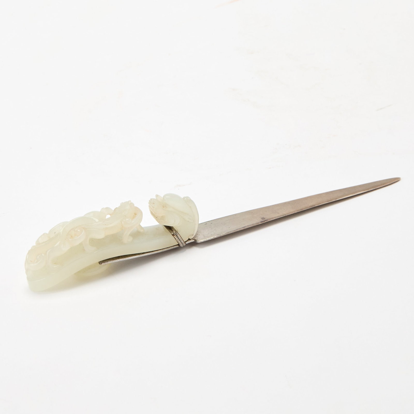 A Chinese White Jade 'Dragon' Belt Hook 18th Century: Of typical form, the terminal fitted with a blade. (Length 3 1/4 inches)