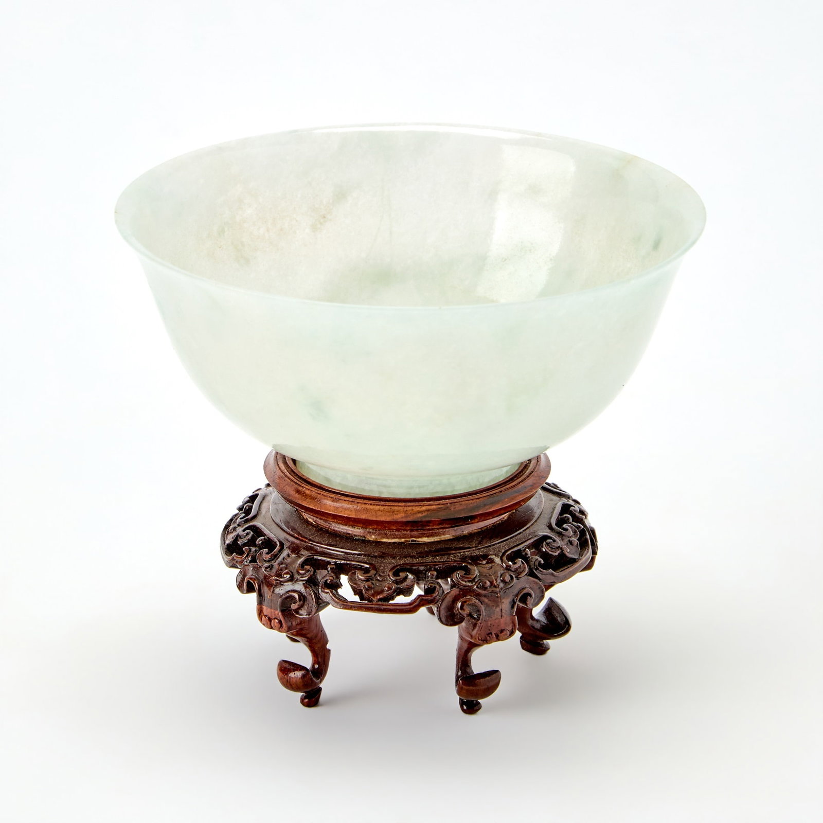 A Chinese Carved Jadeite Bowl Qianlong Mark, 20th Century: The base incised with an apocryphal Qianlong four-character mark and the character Bing. (Diameter 4 3/4 inches)