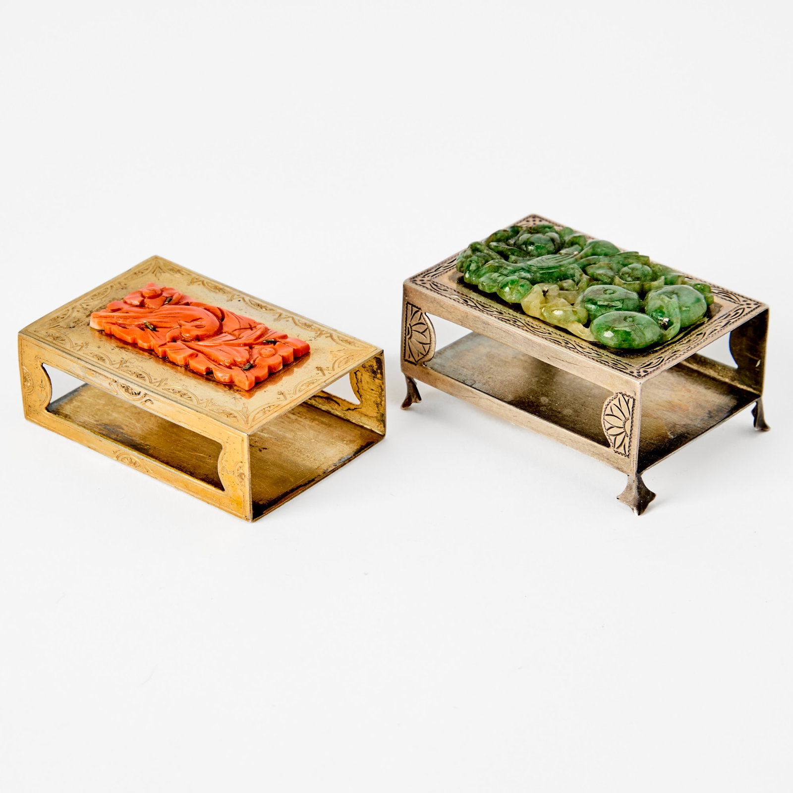 Two Chinese Hardstone-Inset Match Safes Early 20th Century: Each of rectangular form, the hardstone carved with a bird among leafy branches, the underside signed Edward Farmer. (Length of largest 2 1/4 inches)