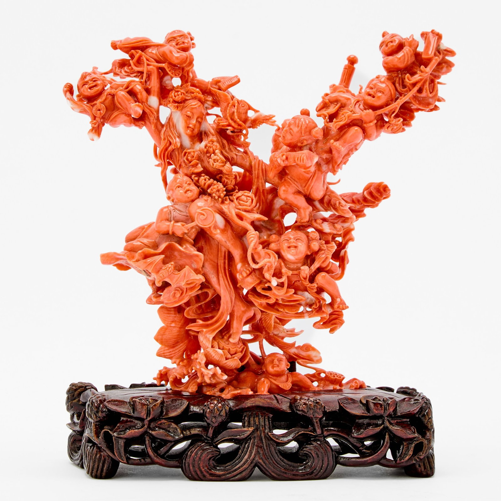 A Chinese Coral Carving of a Figural Group: 20th Century Carved as a celestial female immortal in flight, surrounded by playful boys. Weight 365 grams Height 6 inches