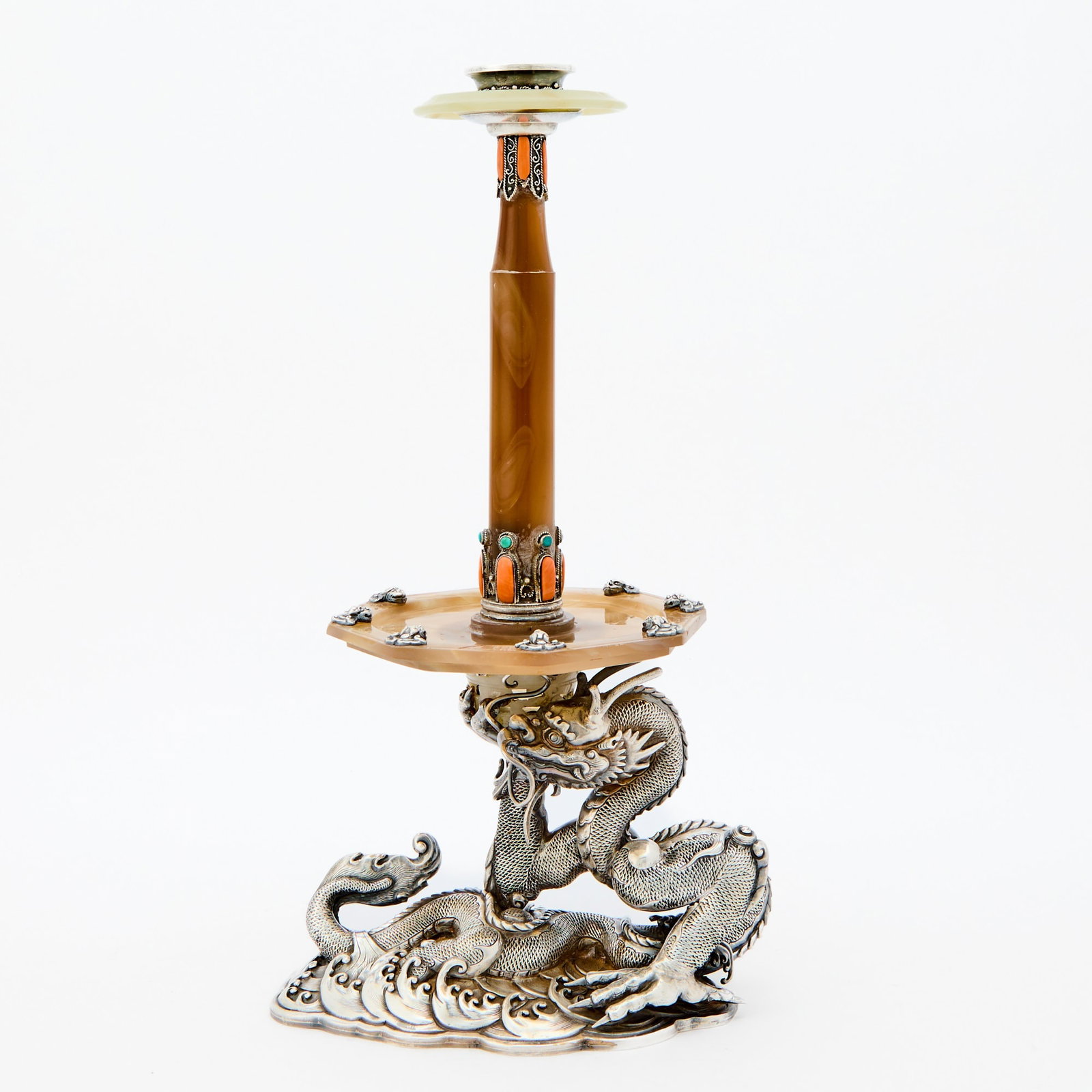 A Fine and Unusual Chinese Silver and Agate Candle Holder Late Qing-Republic Period: The silver dragon-form base supports an octagonal tray with inset silver dragon heads and from which issues a tapering columnar neck set with hardstone beads and supporting a mixed agate and silver ca