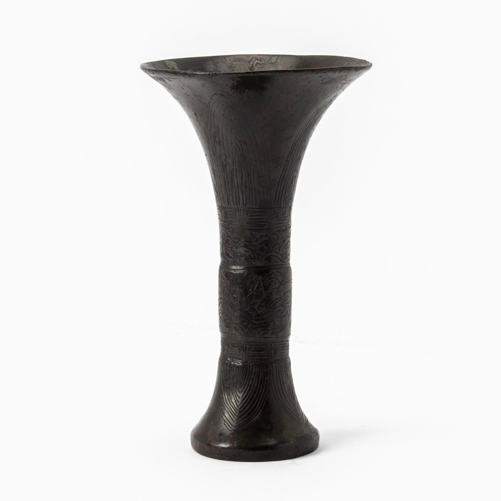 A Chinese Cast Bronze Gu Vase Late Ming-Early Qing Dynasty: Decorated with a band of scrolling lotus and a band of beast masks, all framed by two broad lappet borders. (Height 8 inches)