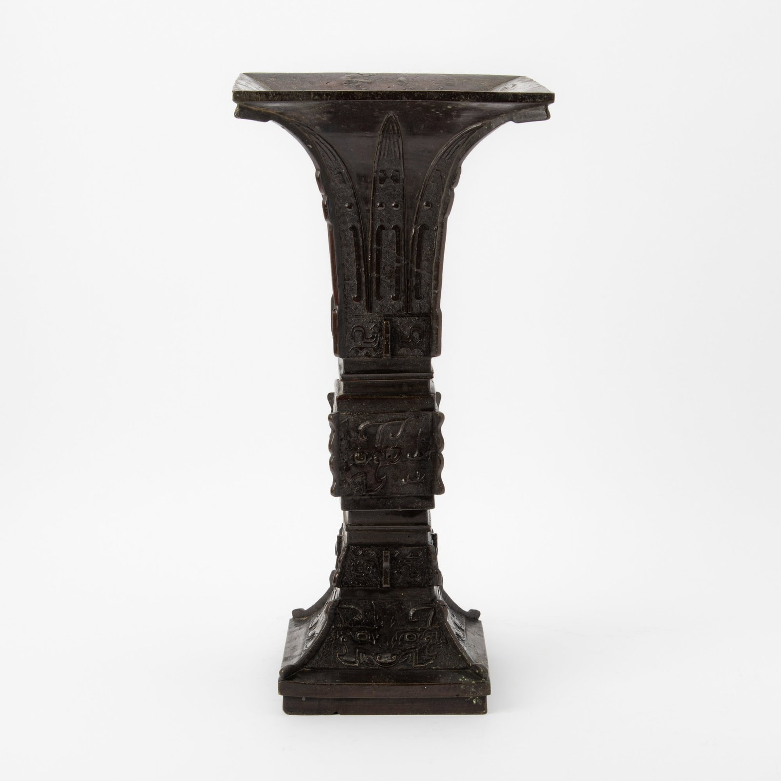 A Large Chinese Bronze Archaistic Gu-form Vase Ming Dynasty: Of square form, with vertical flanges at the corners, decorated with geometric designs and archaistic borders and motifs. (Height 18 1/4 inches)