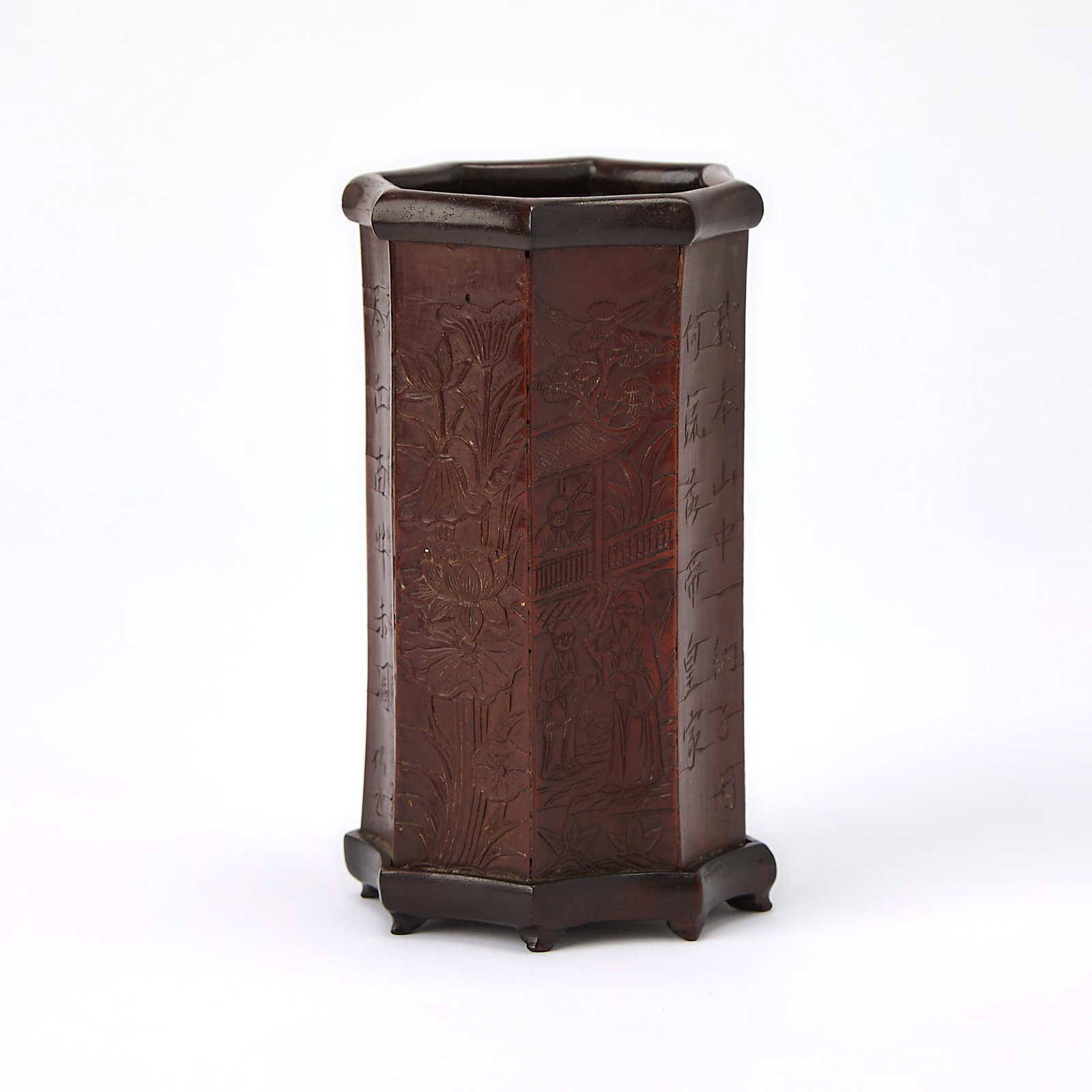 A Chinese Bamboo Brushpot Qing Dynasty: Carved with figures in a garden setting, accompanied by an inscribed poem signed by the artist Tao Yin Zhe. (Height 5 1/2 inches)