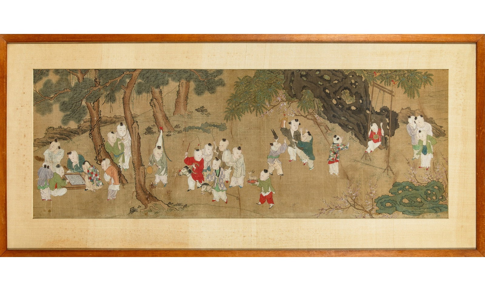 A Chinese School Painting of Boys 17th Century: Ink and color on silk Depicting an assemblage of joyful boys engaged in various activities in an outdoor setting Matted and framed (Sight 33 1/4 x 11 3/4 inches)
