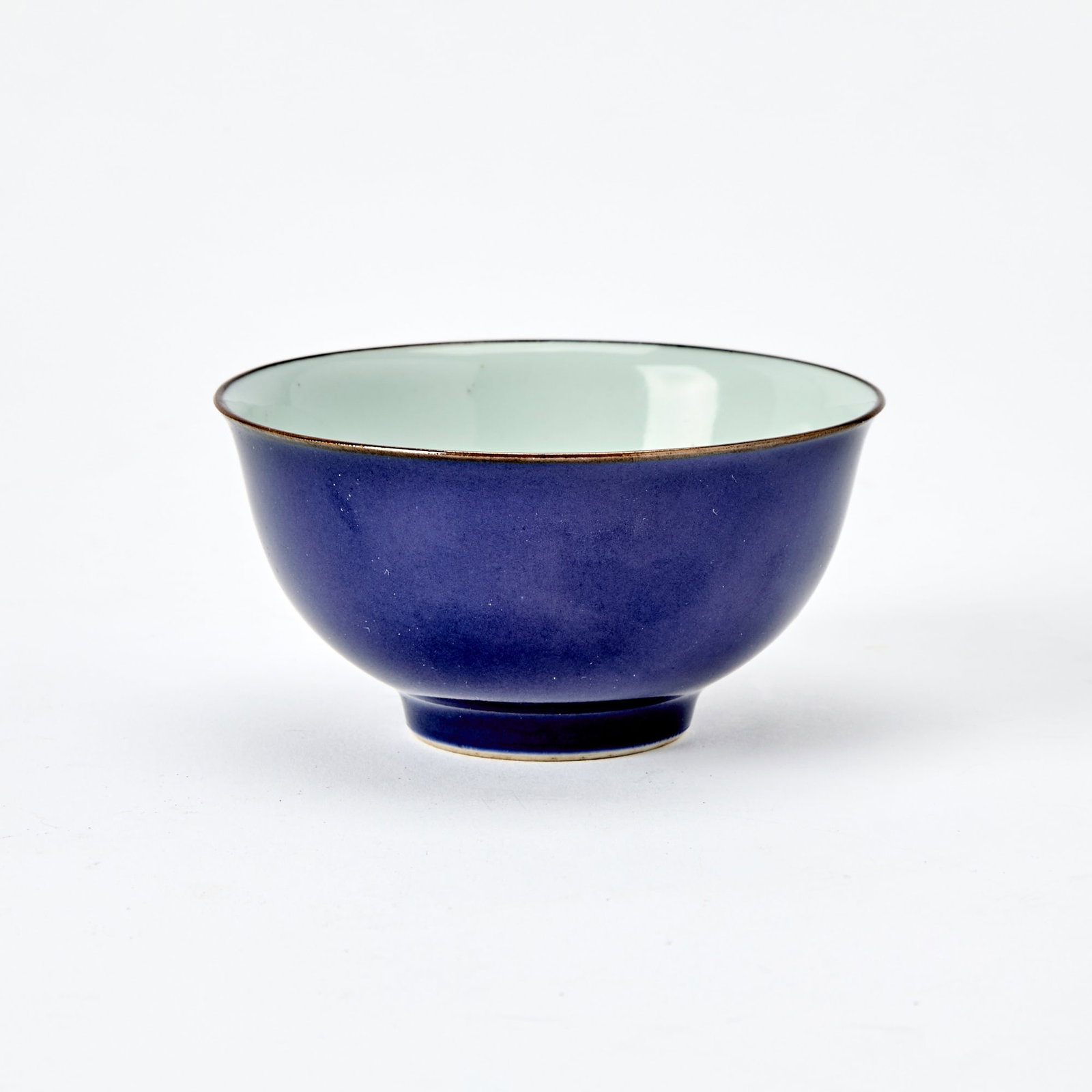 A Chinese Blue Glazed Porcelain Bowl Jingwei Tang Zhi Mark, 18th-19th Century: The exterior covererd in lustrous blue glaze below brown-glazed rim. (Diameter 3 3/4 inches)