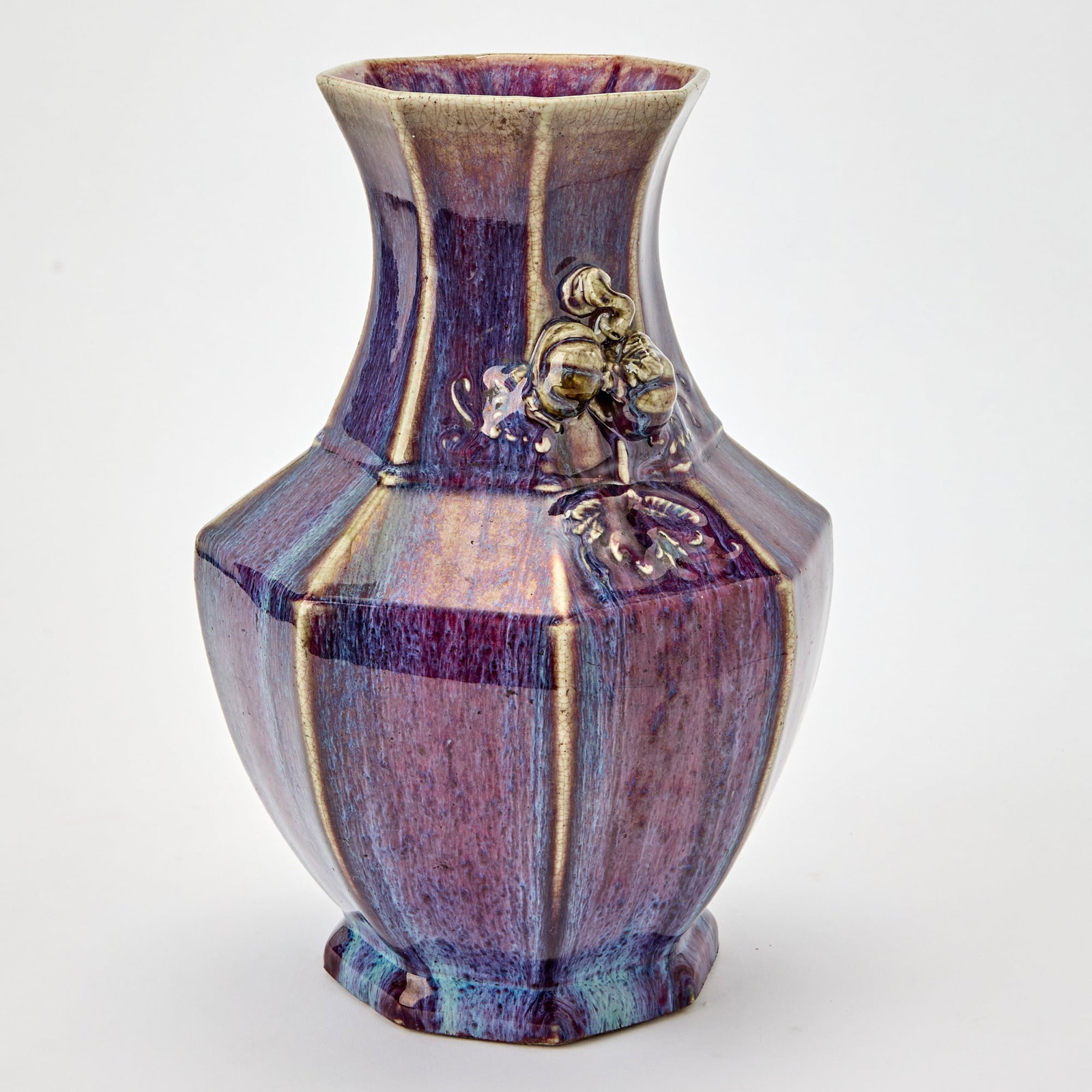 A Chinese Flambe Glazed Porcelain Octagonal Vase 19th Century: Molded with paired melons borne on leafy branches as handles, the exterior covered in a lustrous lavender glaze streaked with pale blue. (Height 13 inches) Overall good condition.