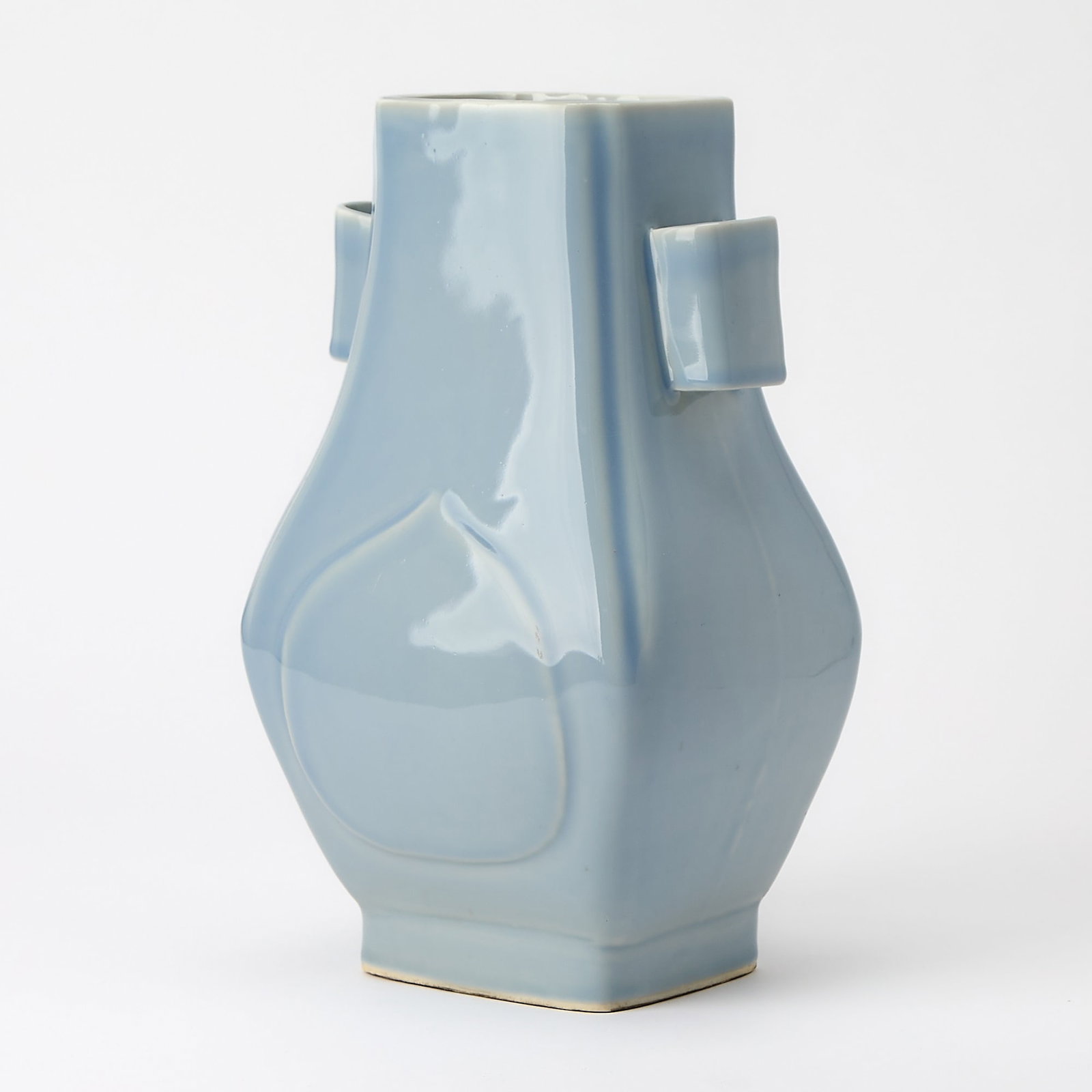 A Chinese Clair-de-lune Glazed Porcelain Vase, Fanghu Guangxu Mark and of the Period: Of square form with tubular handles, the body molded with apricot-shaped raised panels. (Height 12 1/2 inches)