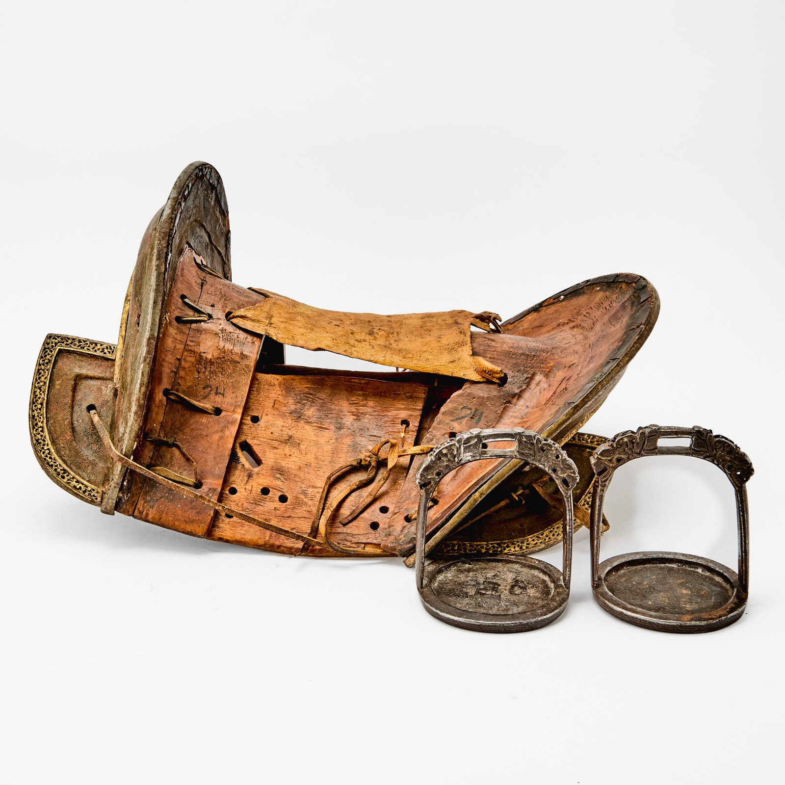 A Tibetan Gilded Iron and Lacquered Wood Saddle Likely 19th Century