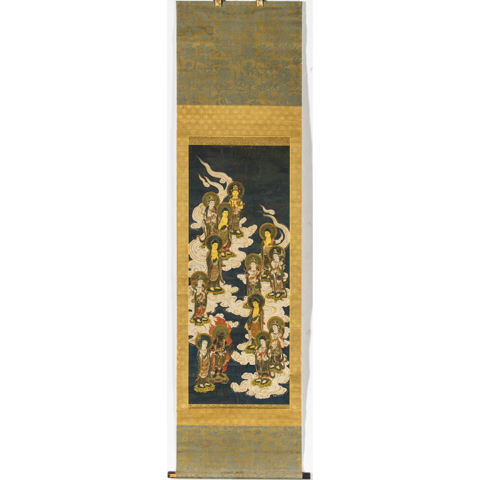 A Japanese School Buddhist Painting Edo Period: Ink and color on paper; depicting standing bodhisattvas upon clouds against an indigo blue ground; mounted to hanging scroll. (Sight 39 1/4 x 15 1/4 inches)