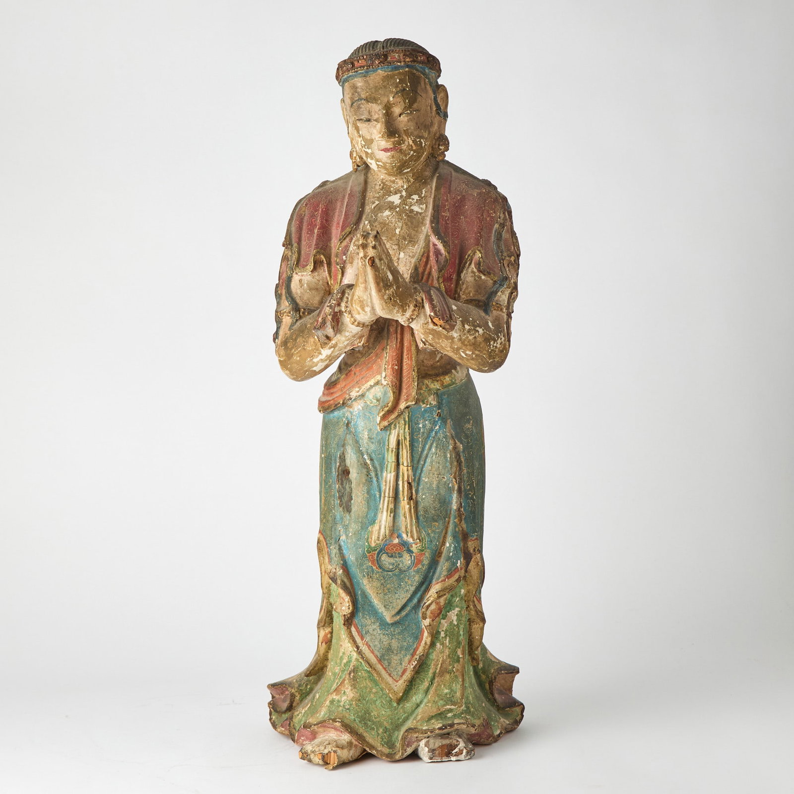 A Chinese Carved Wood and Gesso Figure Ming Dynasty: Depicting a female Buddhist attendant in colorful robes. (Height 26 1/2 inches)